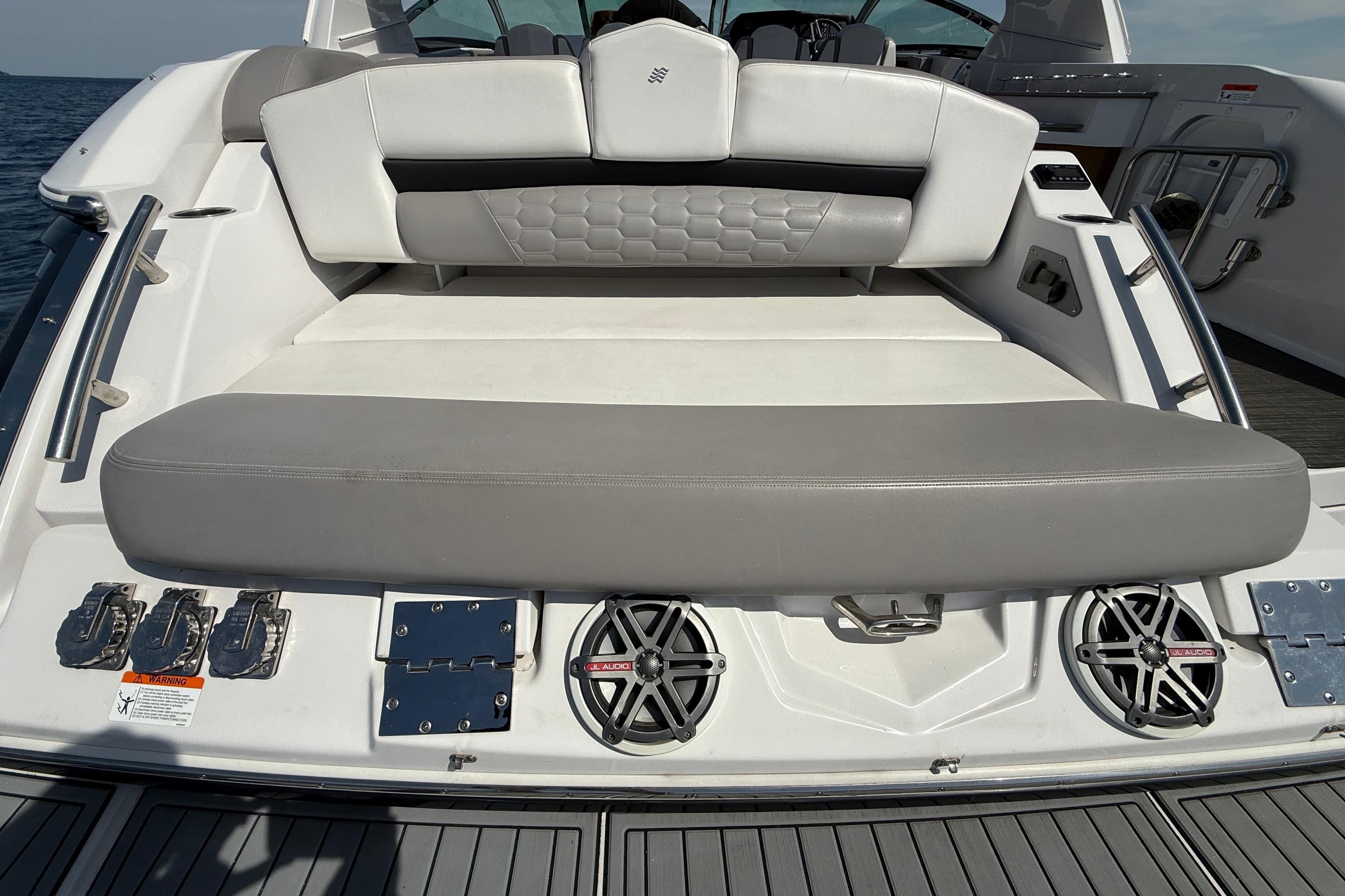2018 Four Winns H350 boat interior with cushioned seating and audio speakers.