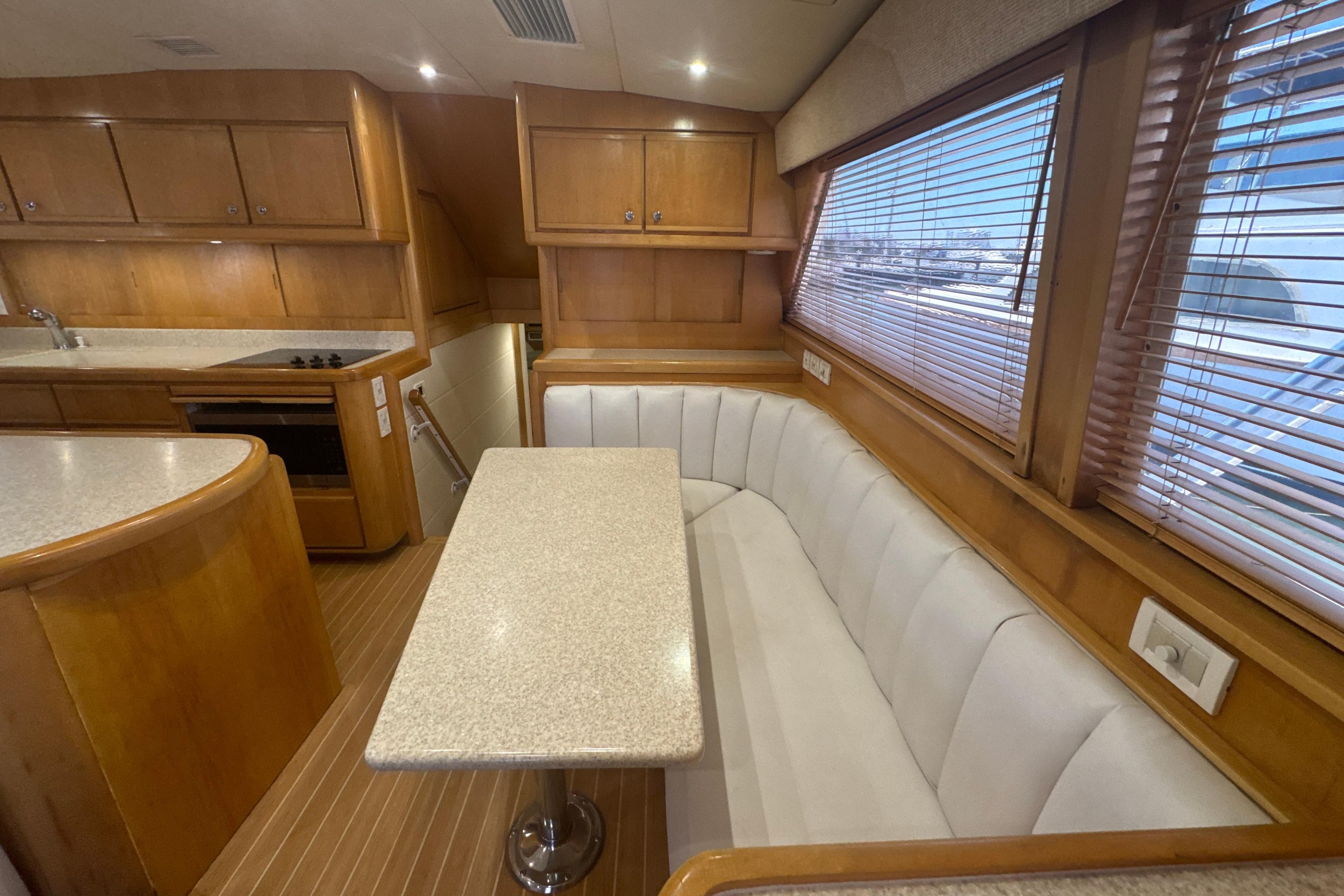 Luxurious interior of a 1997 Bertram 54 Convertible yacht with elegant wood finishes.