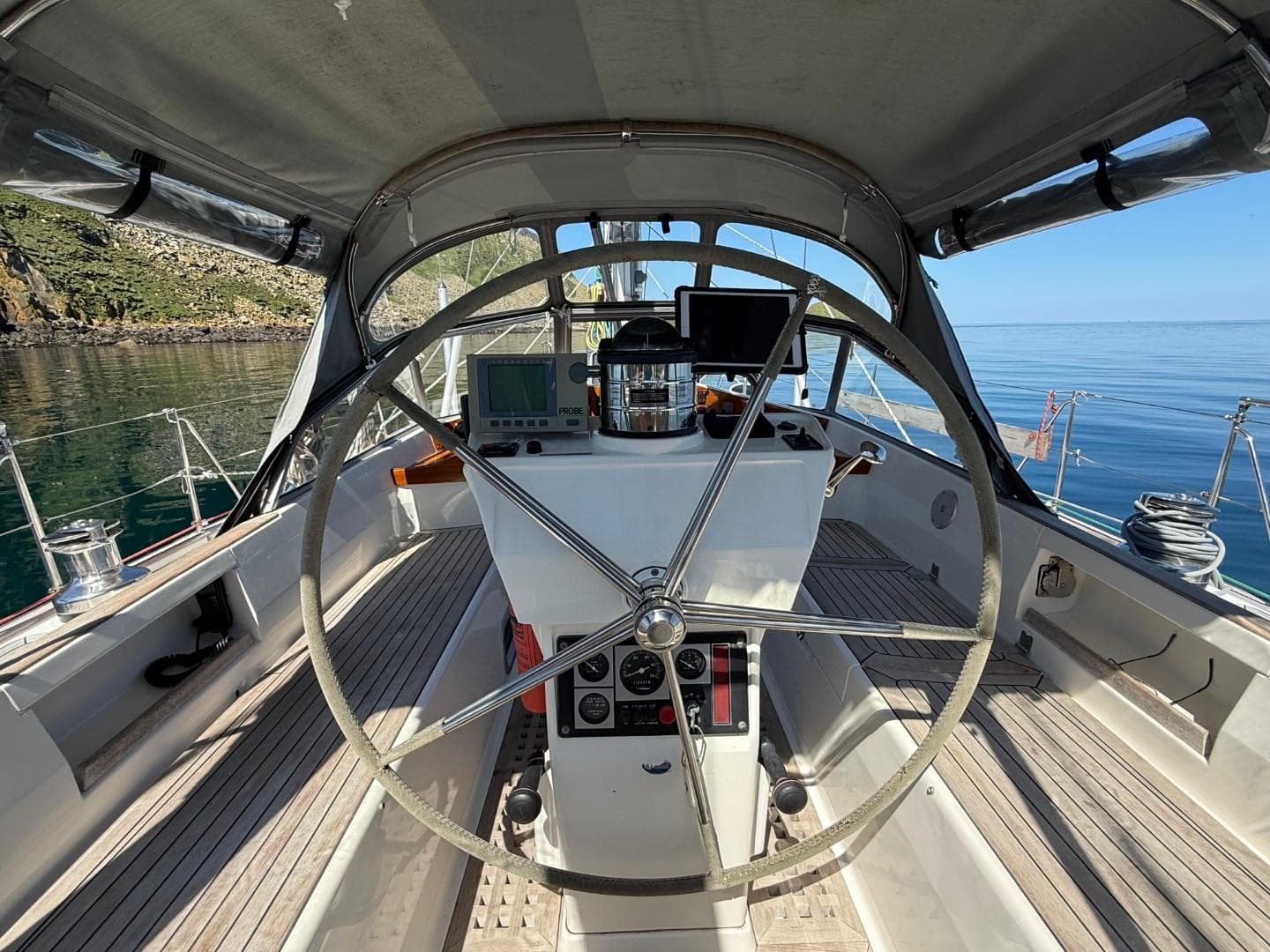 Cockpit view of 2002 Najad 490 sailboat with steering wheel and navigation instruments.