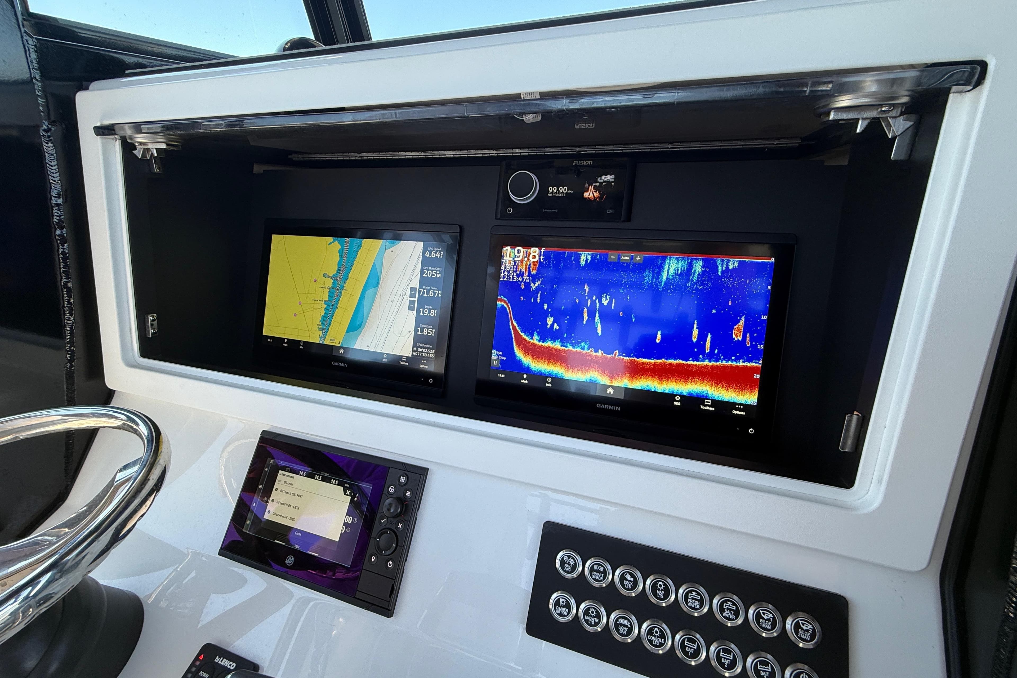 2026 Onslow Bay boat dashboard with dual Garmin displays and control panel.