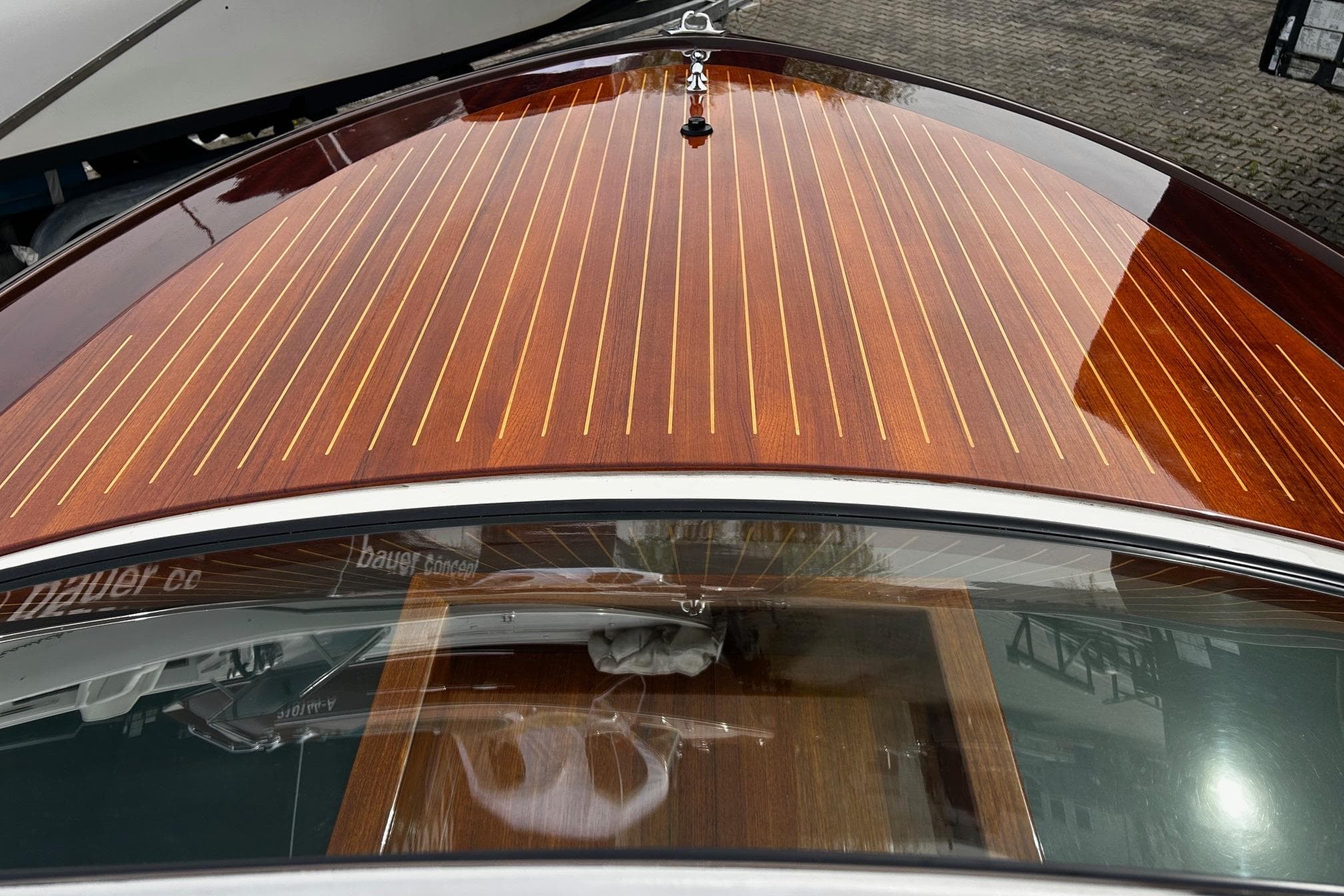 2014 Colombo Bellagio boat with polished wooden deck and sleek design.