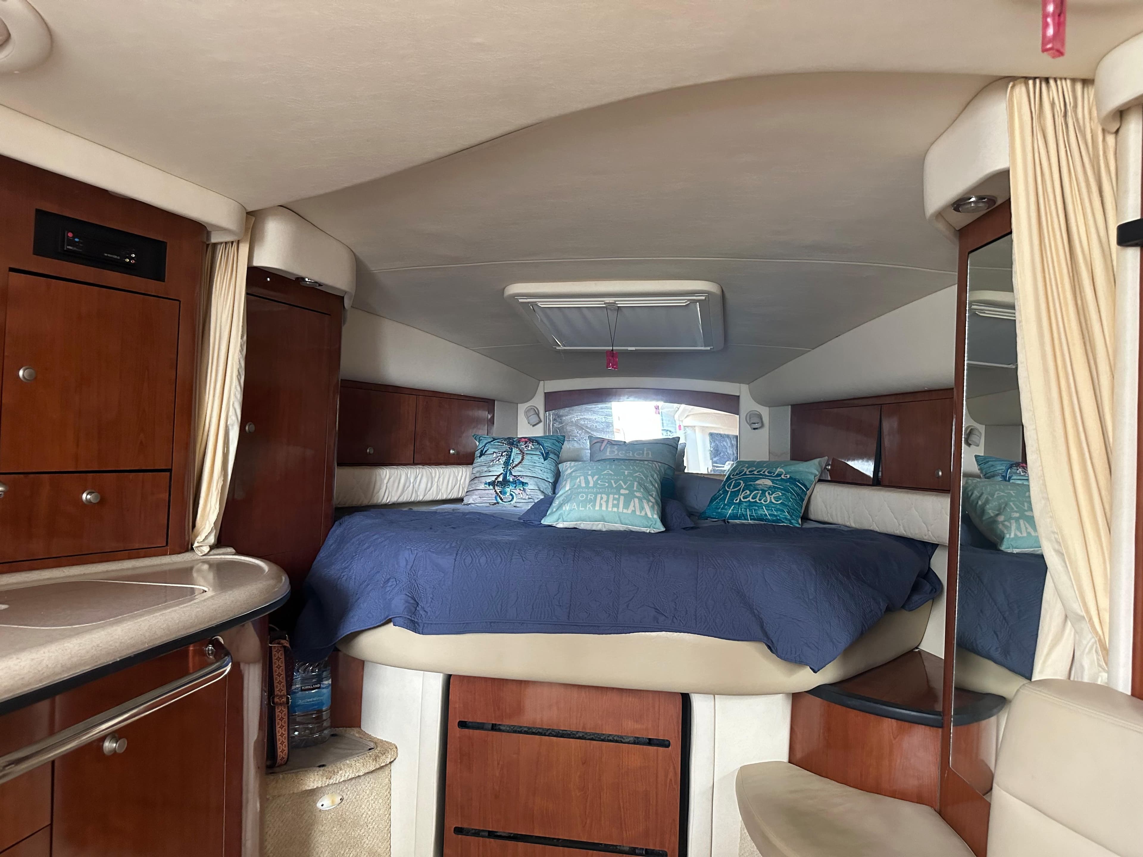 Interior cabin of a 2006 Sea Ray 340 Sundancer yacht with bed and storage.