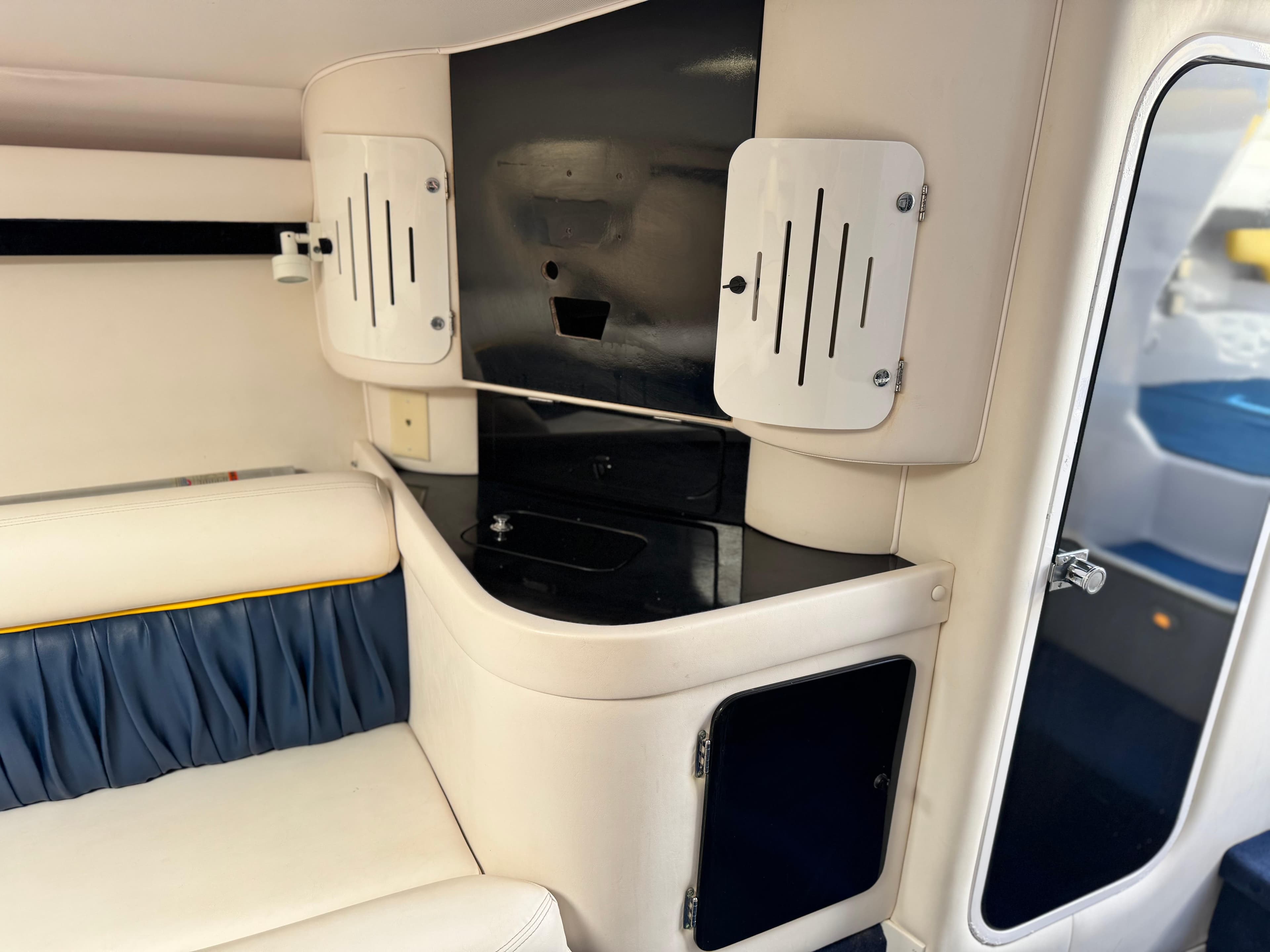 Interior of a 2004 Donzi 38 ZX boat, featuring sleek cabinetry and seating.
