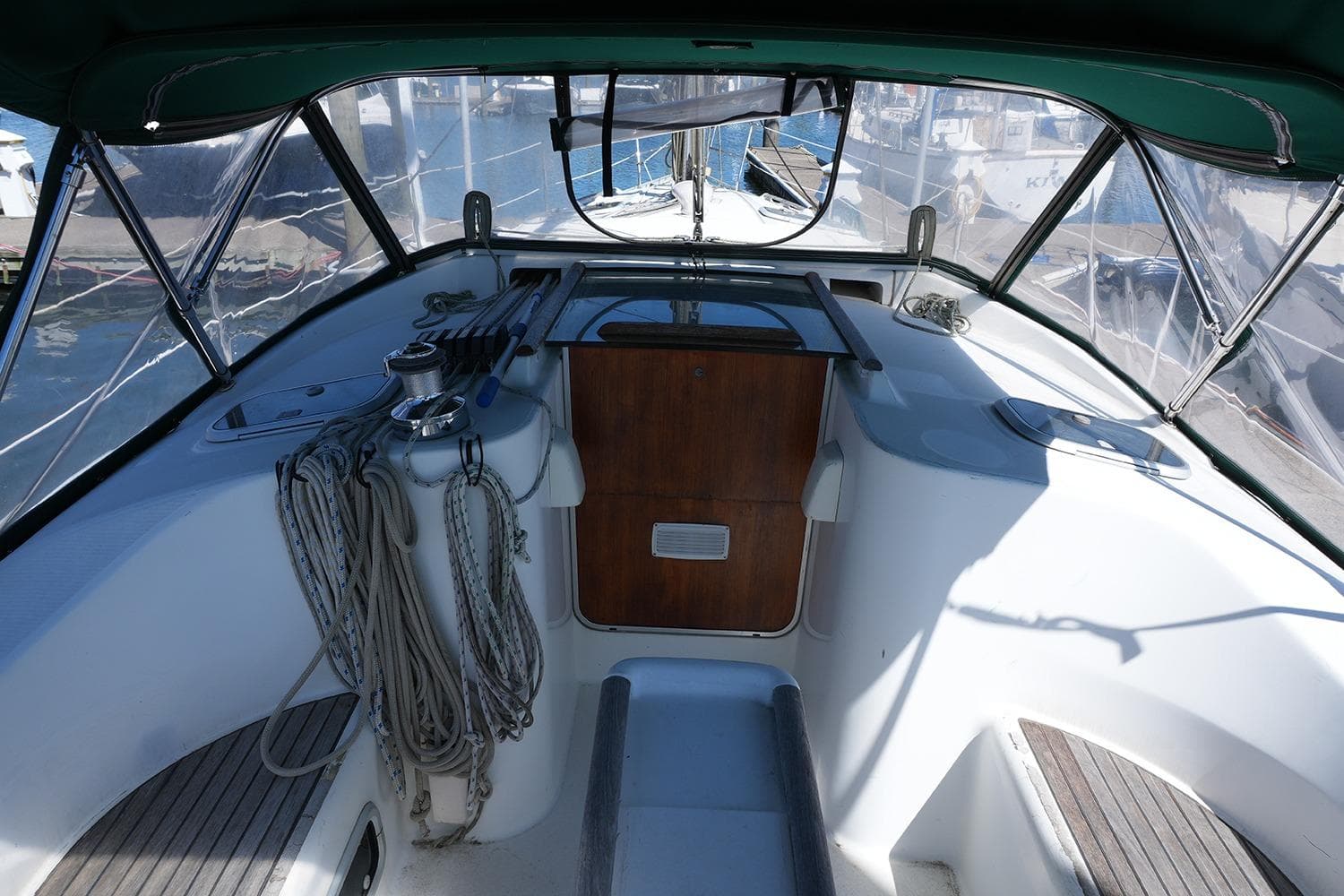 Cockpit of a 1999 Beneteau 381 sailboat with ropes and winches.