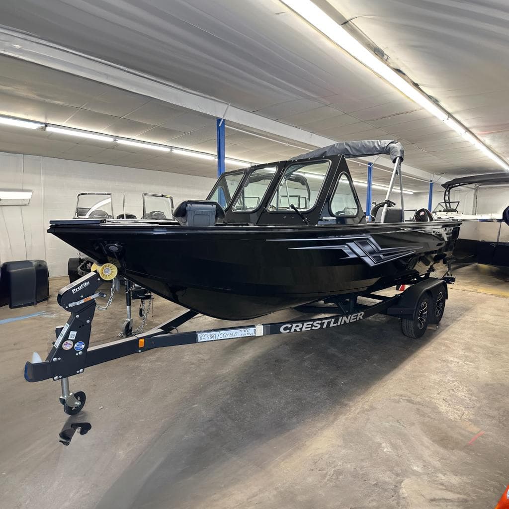 2026 Crestliner 2050 Commander boat in showroom, black exterior, on trailer.