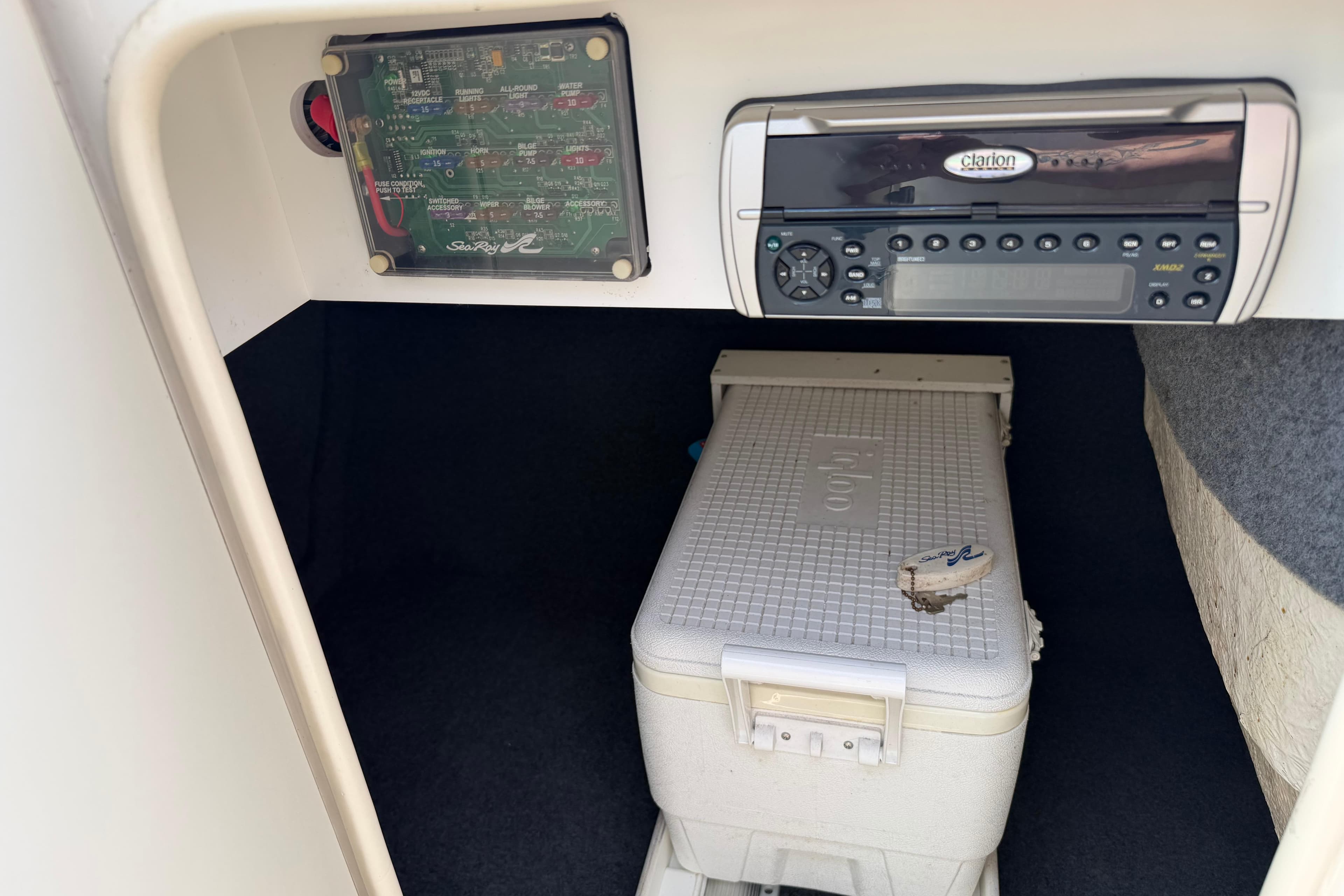 2003 Sea Ray 240 Sundeck interior with Clarion stereo and cooler storage.