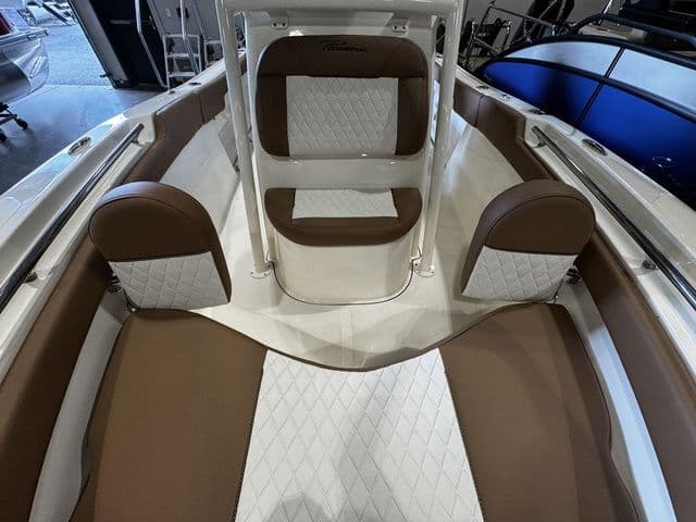 2025 Pioneer ISLANDER 202 boat interior with brown and white cushioned seating.