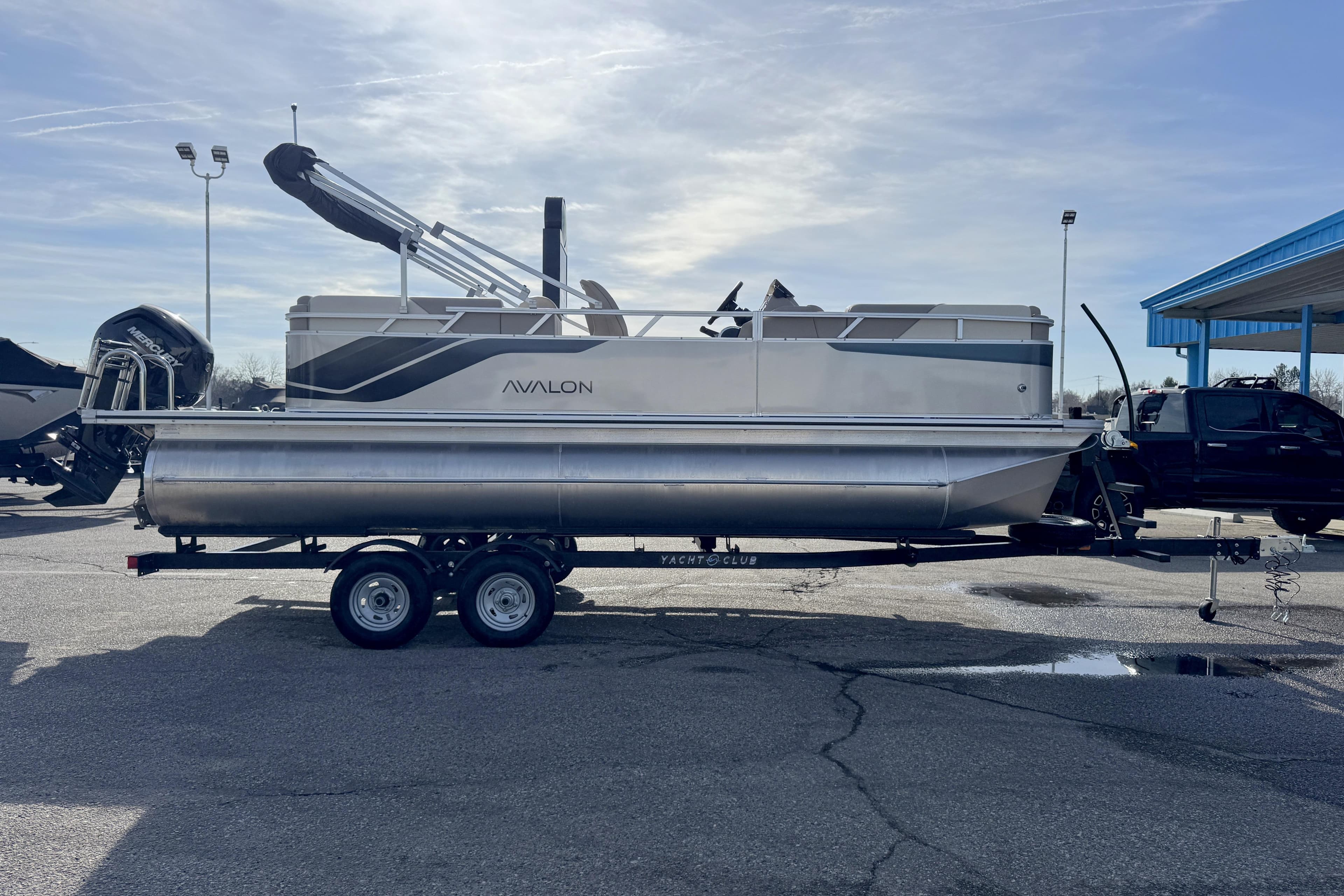 2026 Avalon 2180 23 Venture QL pontoon boat on trailer in parking lot.