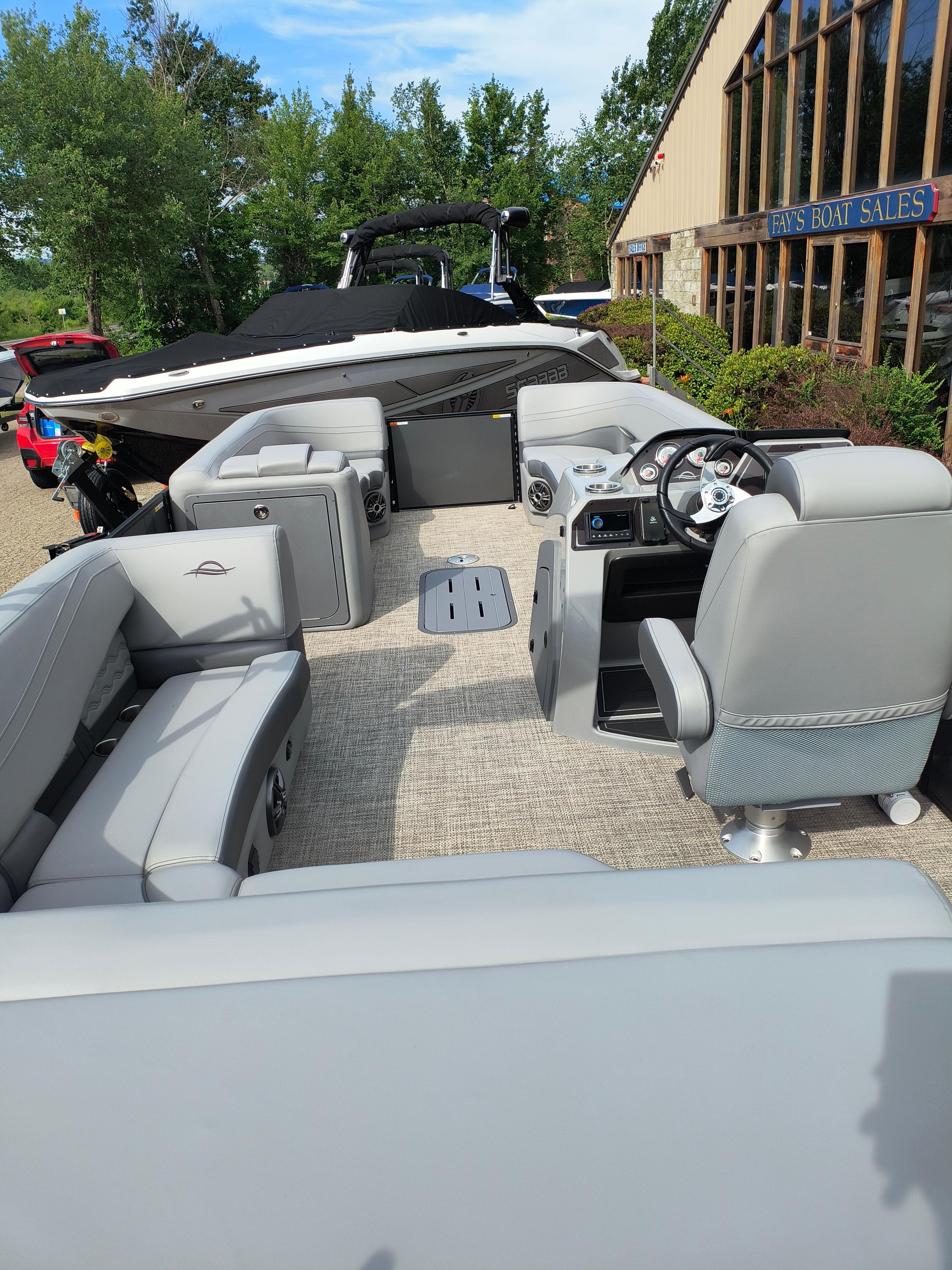 2025 SunCatcher Fusion 322C pontoon boat interior with modern seating and steering console.