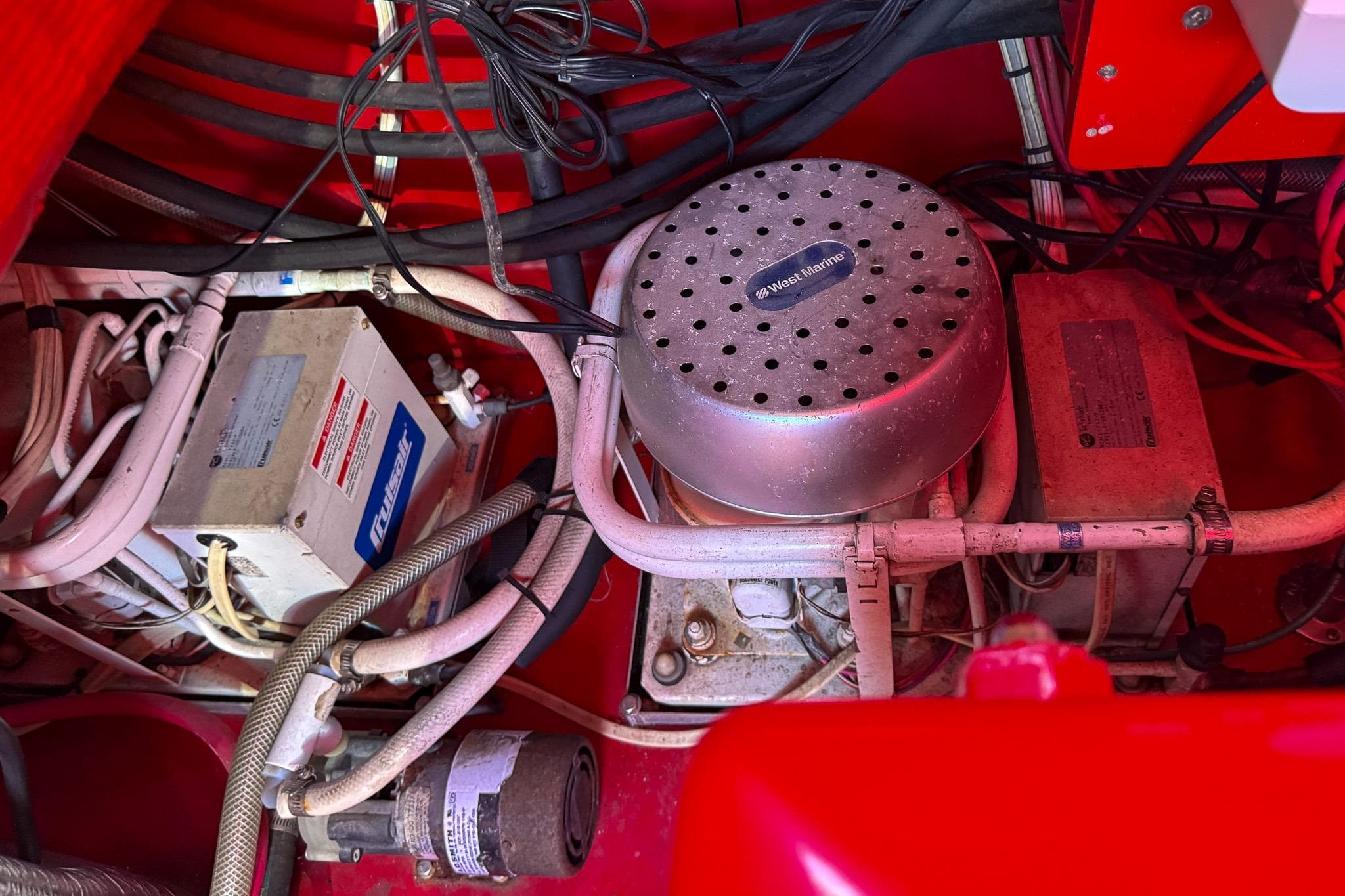 Engine compartment of a 2002 Hallett Custom High Performance Express Cruiser with wiring and components.