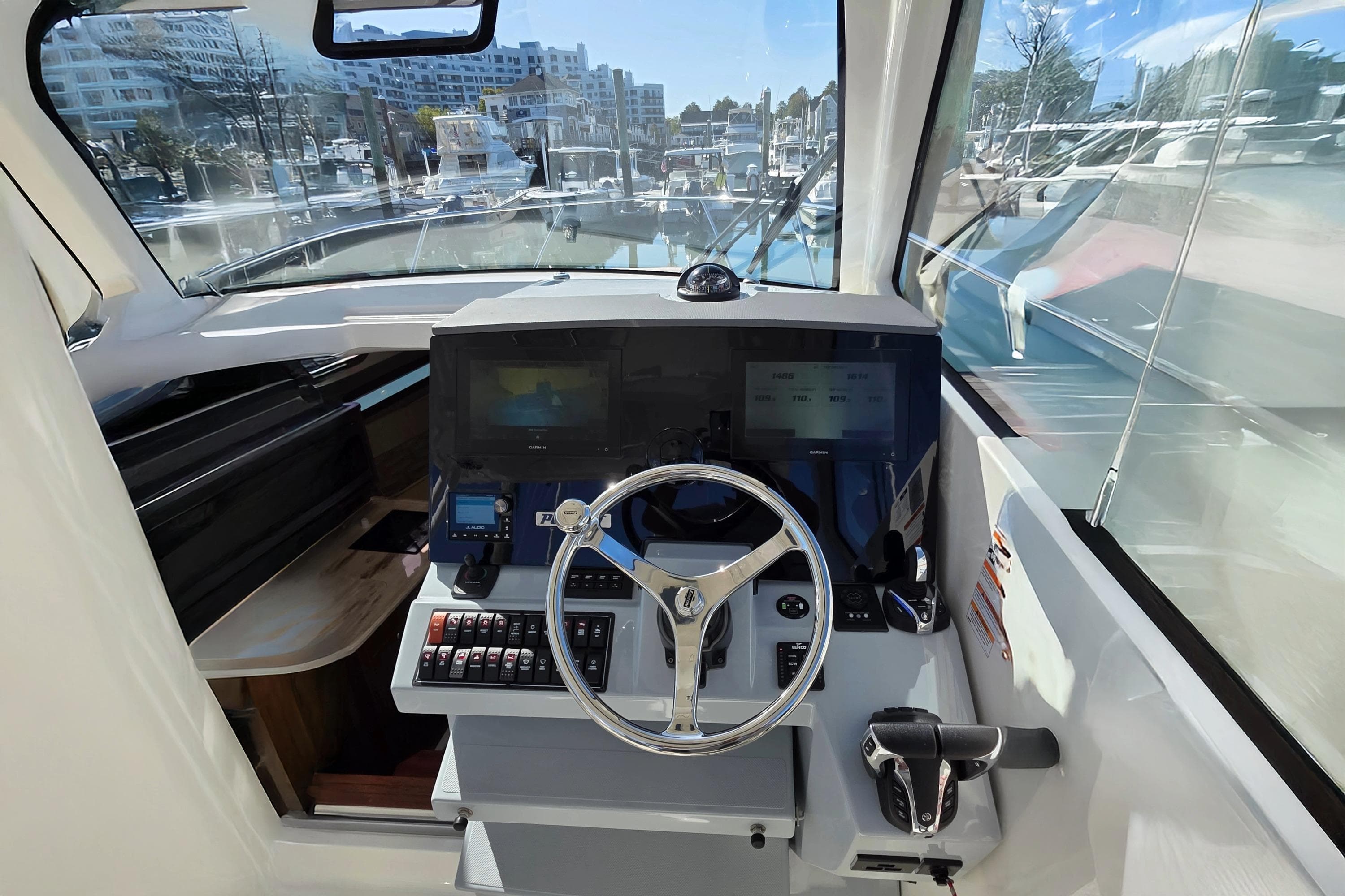 2024 Pursuit OS 325 Offshore helm with modern controls and navigation screens.