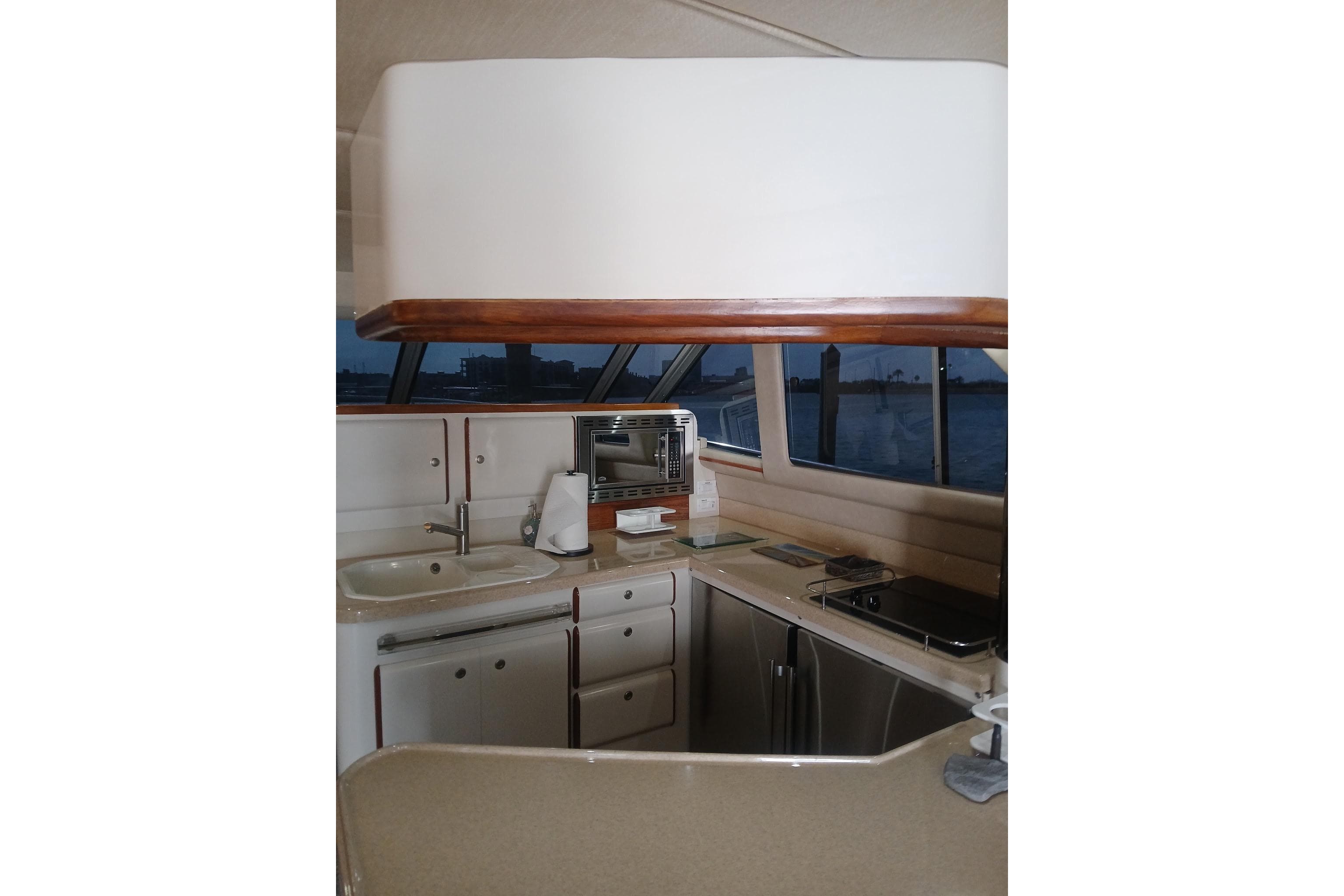 Interior view of 1996 Sea Ray 550 Sedan Bridge yacht kitchen area.