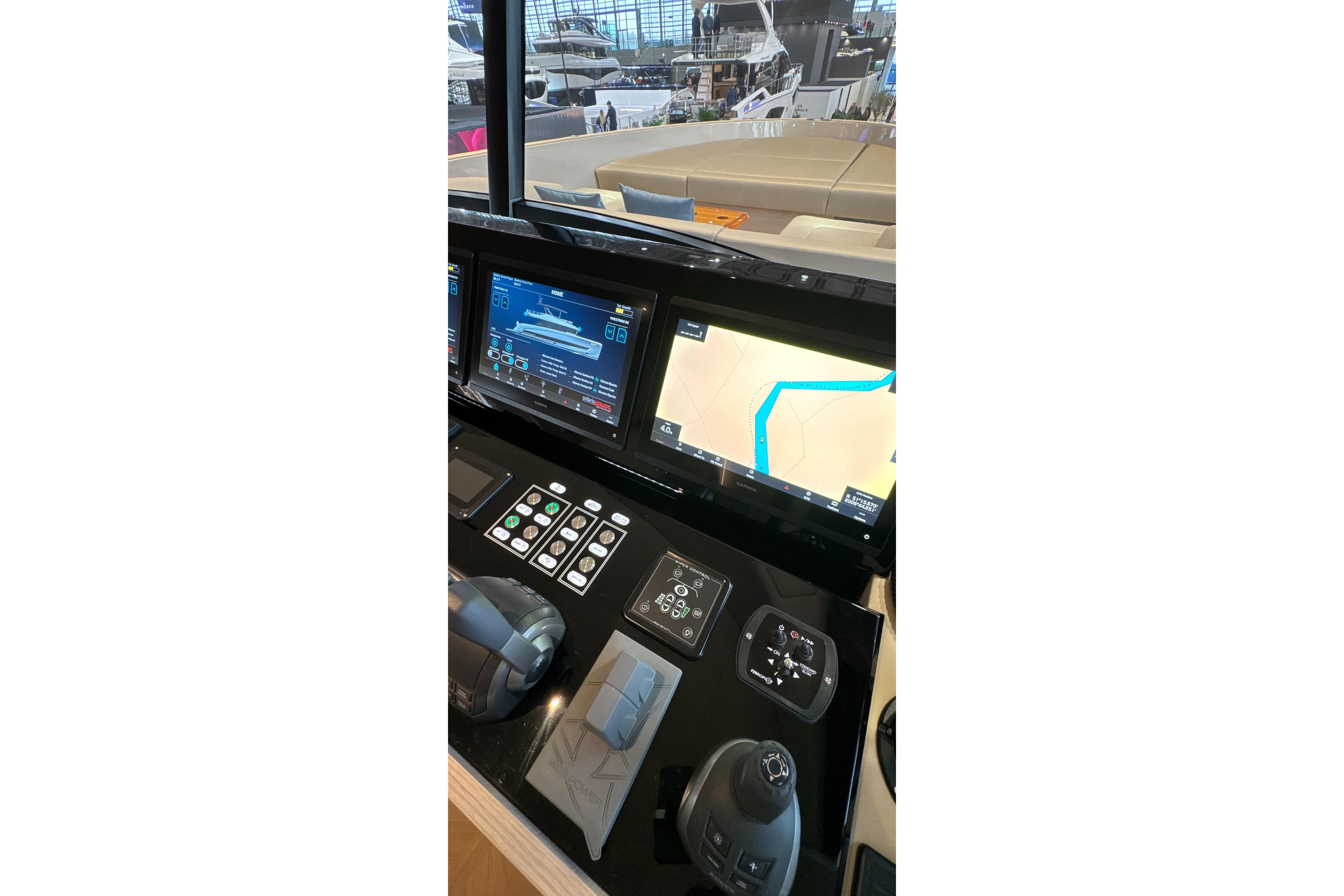 Control panel of 2026 Solaris Power 70 Long Range yacht with navigation screens.