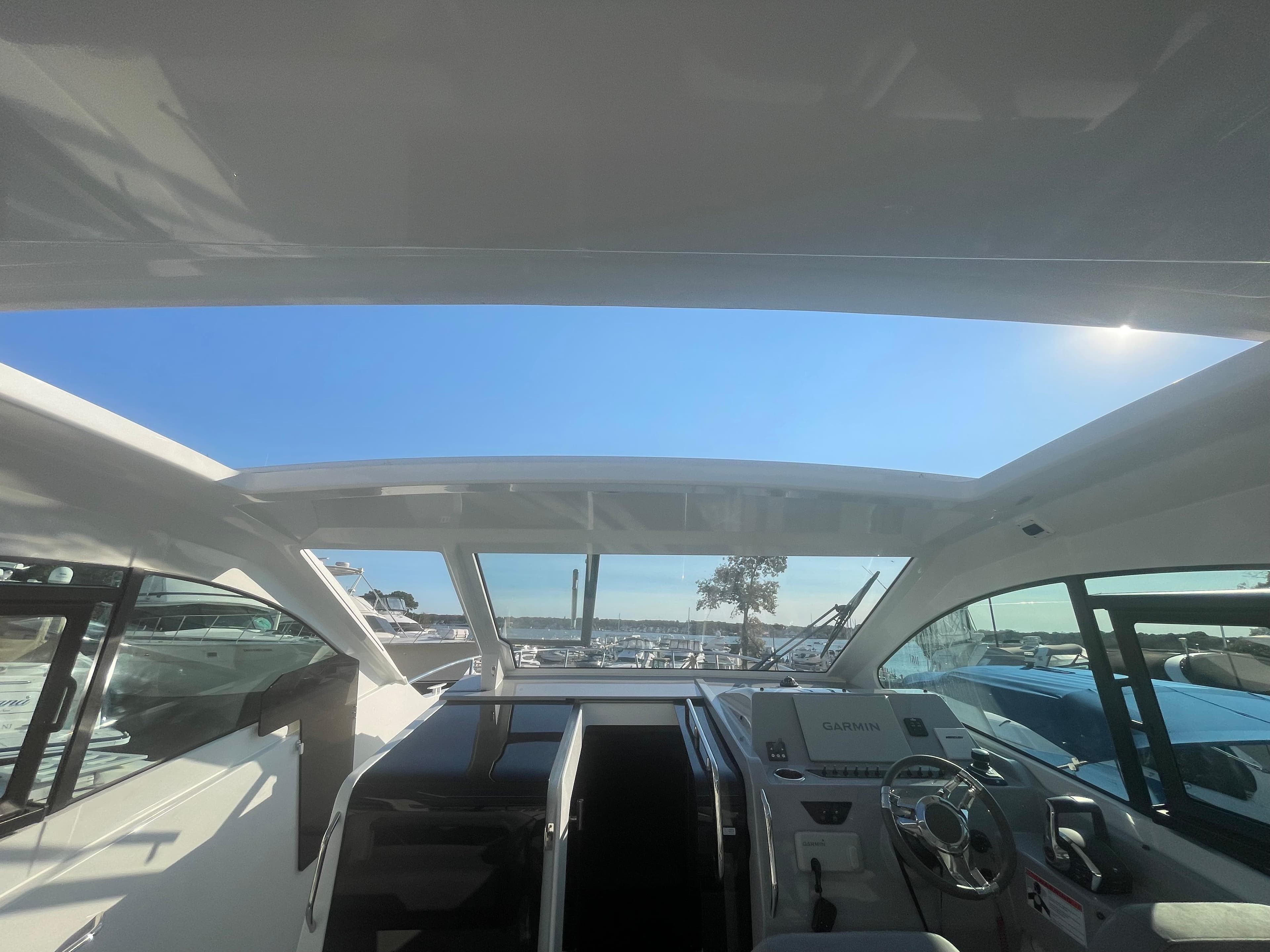 2024 Beneteau Gran Turismo 32 cockpit with panoramic roof and modern controls.