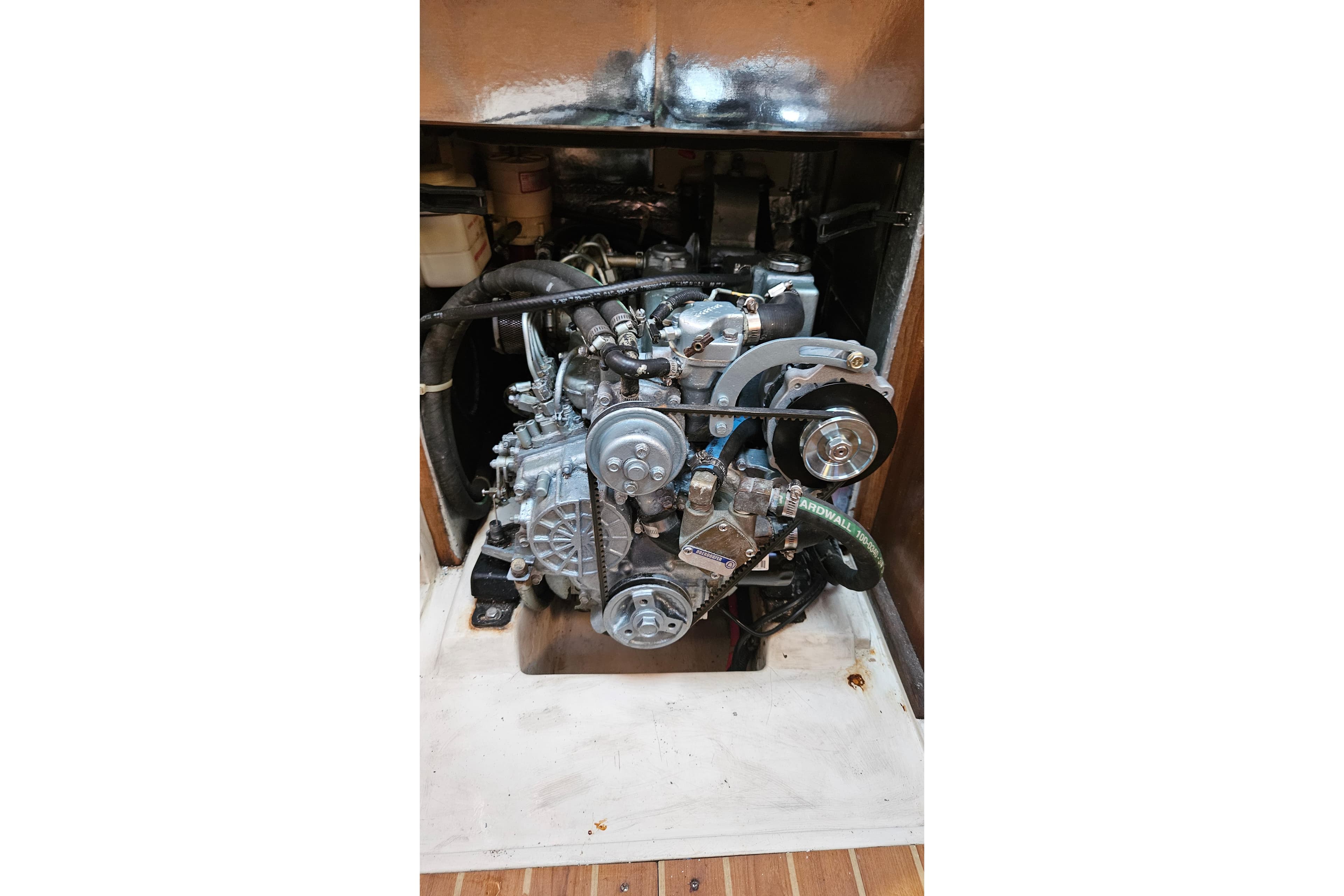 Engine compartment of a 2005 Catalina 350 sailboat, showcasing mechanical components.