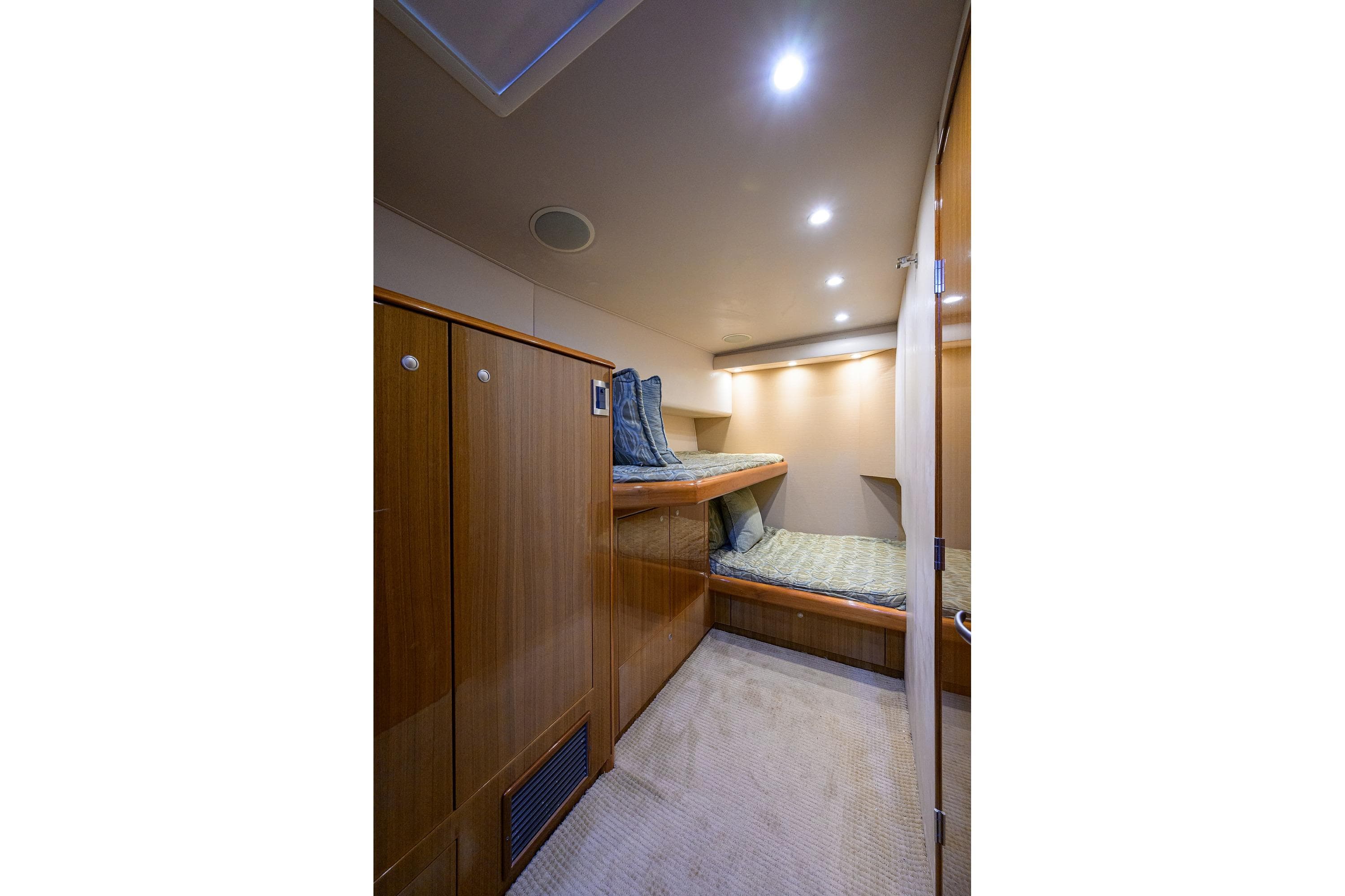 Interior cabin of 2007 Viking 56 Convertible yacht with bunk beds and wooden cabinetry.