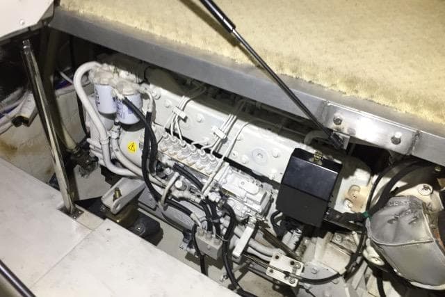 Engine compartment of a 2004 Carver 420 Mariner, showcasing mechanical components and wiring.