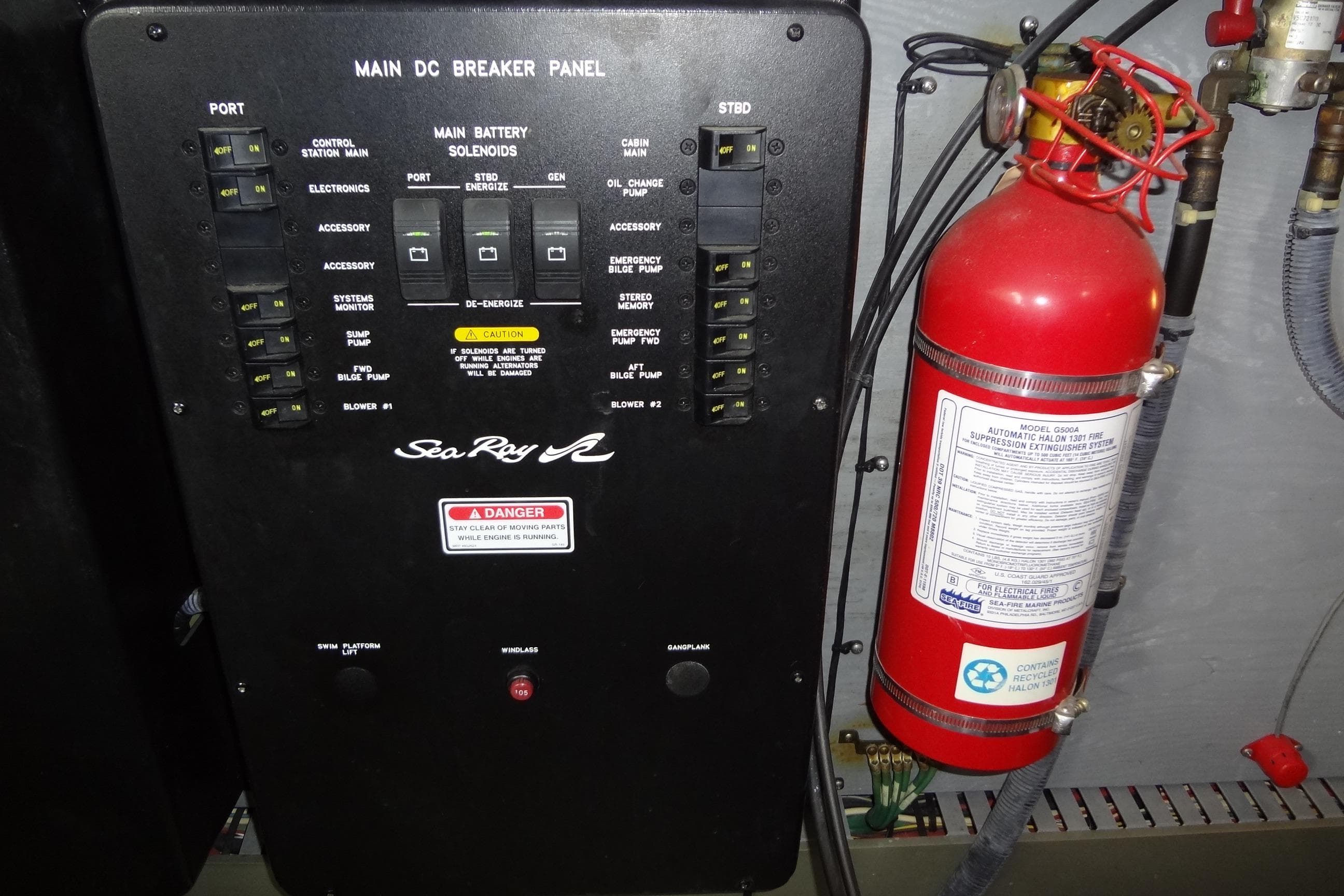 Main DC breaker panel and fire extinguisher on 2001 Sea Ray 380 Sundancer boat.