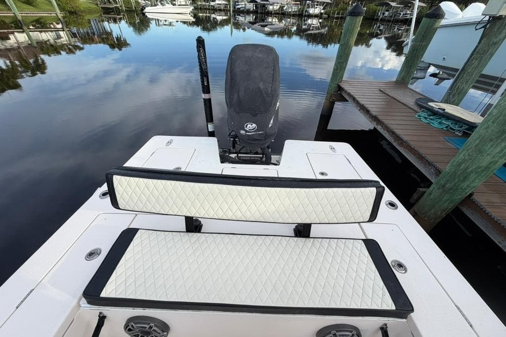 2008 Maverick 21 Master Angler boat with cushioned seating and outboard motor at dock.