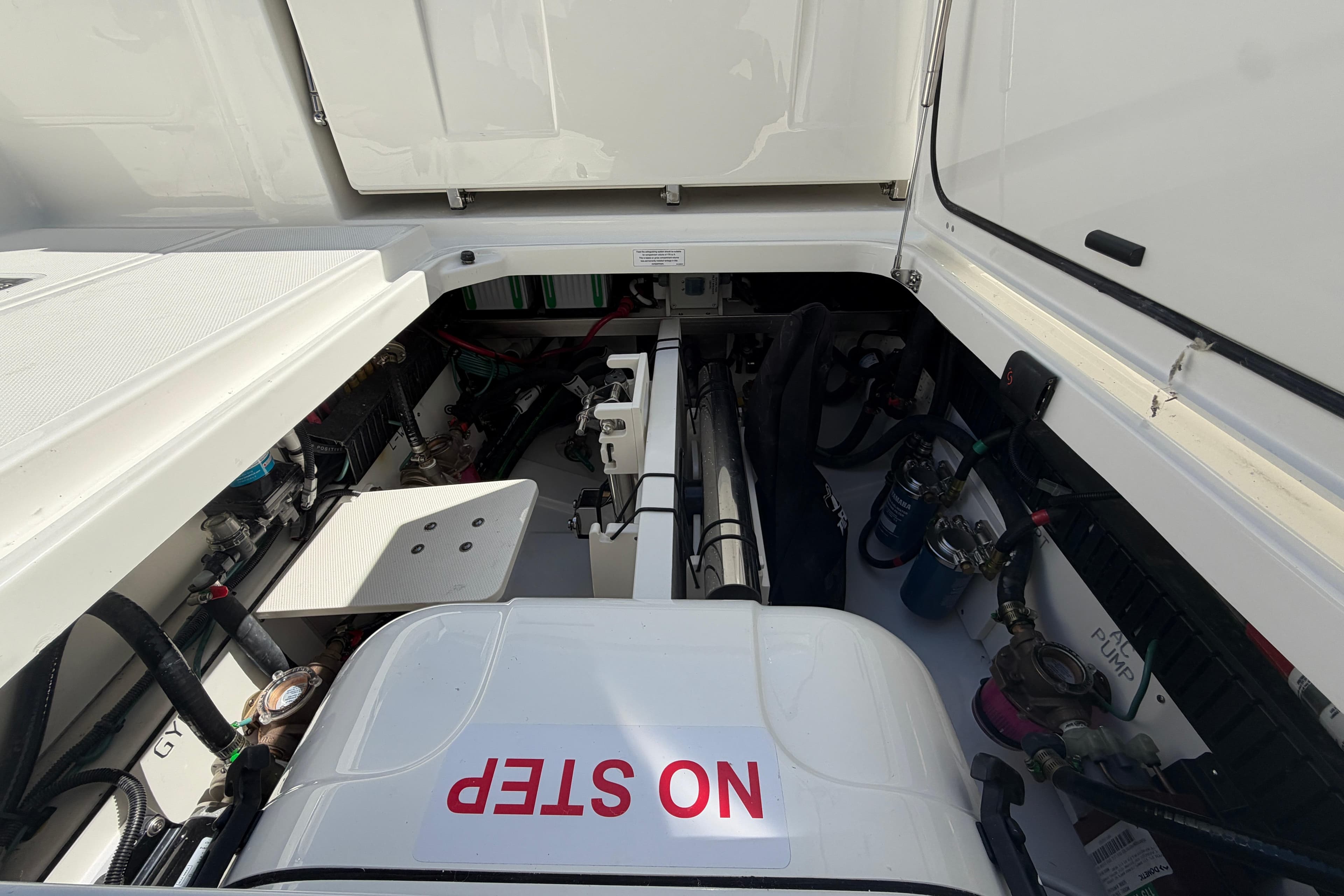 Engine compartment of 2026 Pursuit S 358 Sport boat, featuring "NO STEP" warning.