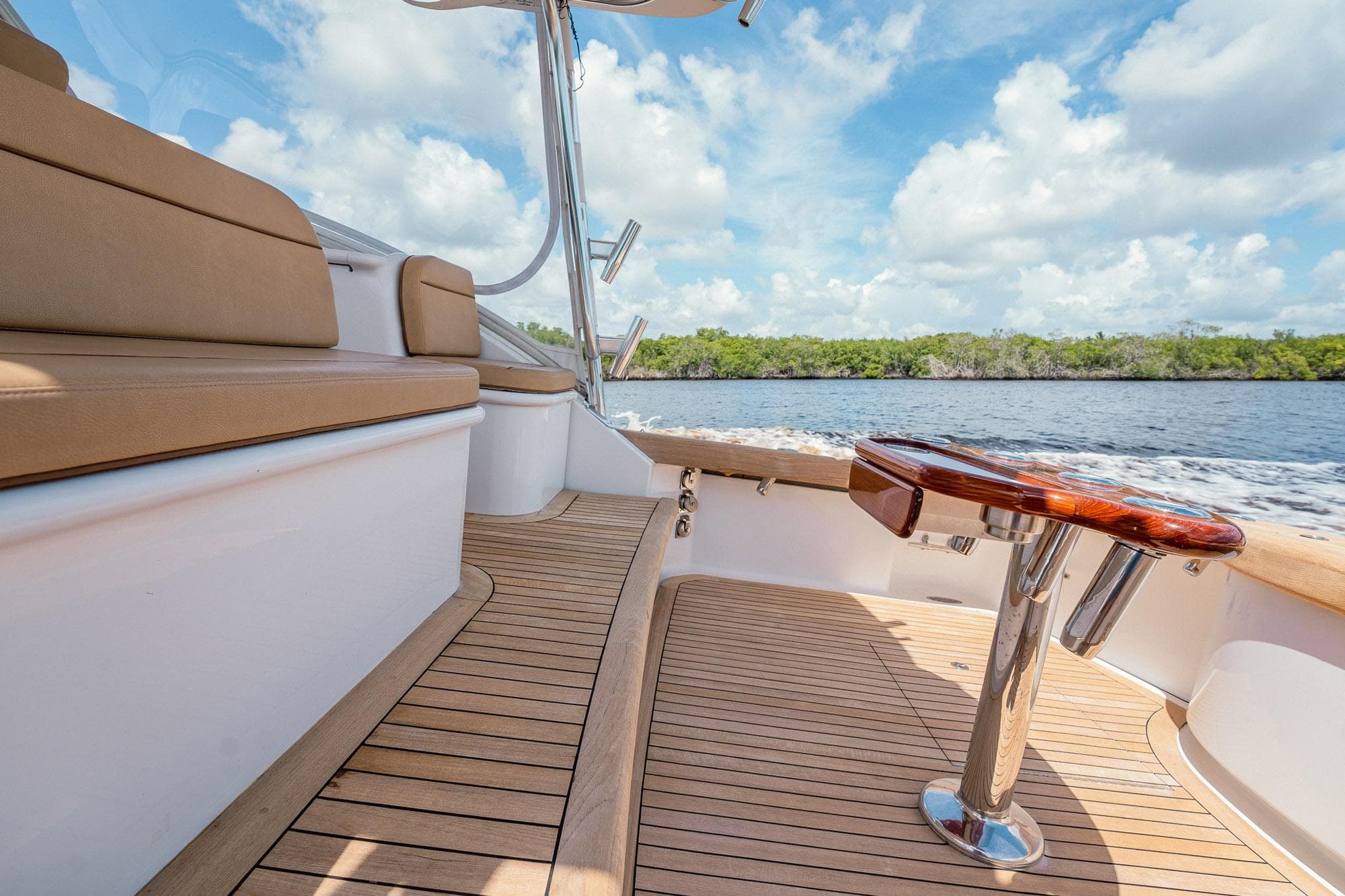Luxurious 2012 Winter Custom Yachts 38 Express with teak deck and scenic water view.