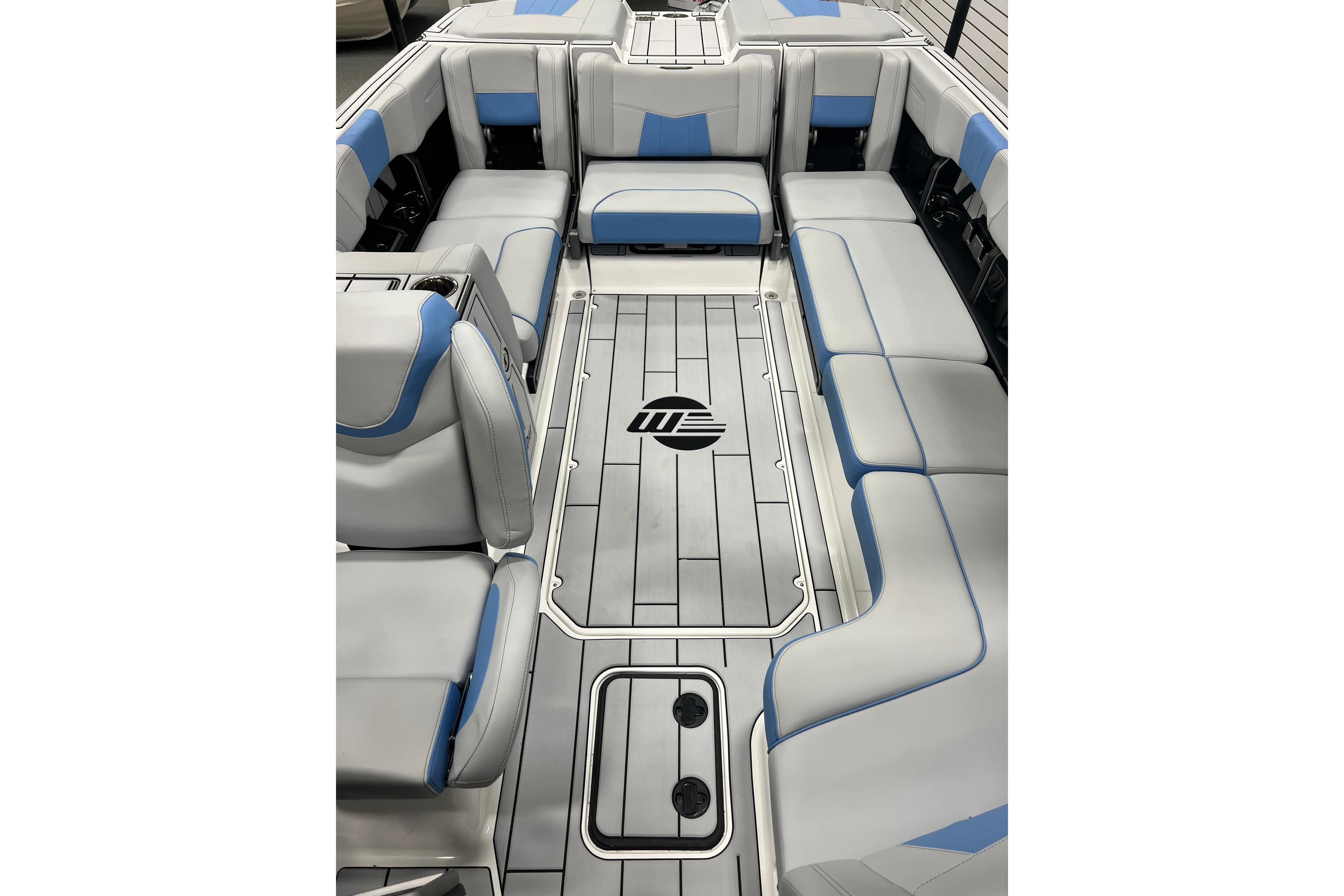 2024 Malibu Wakesetter 24 MXZ interior with gray and blue seating, spacious layout.