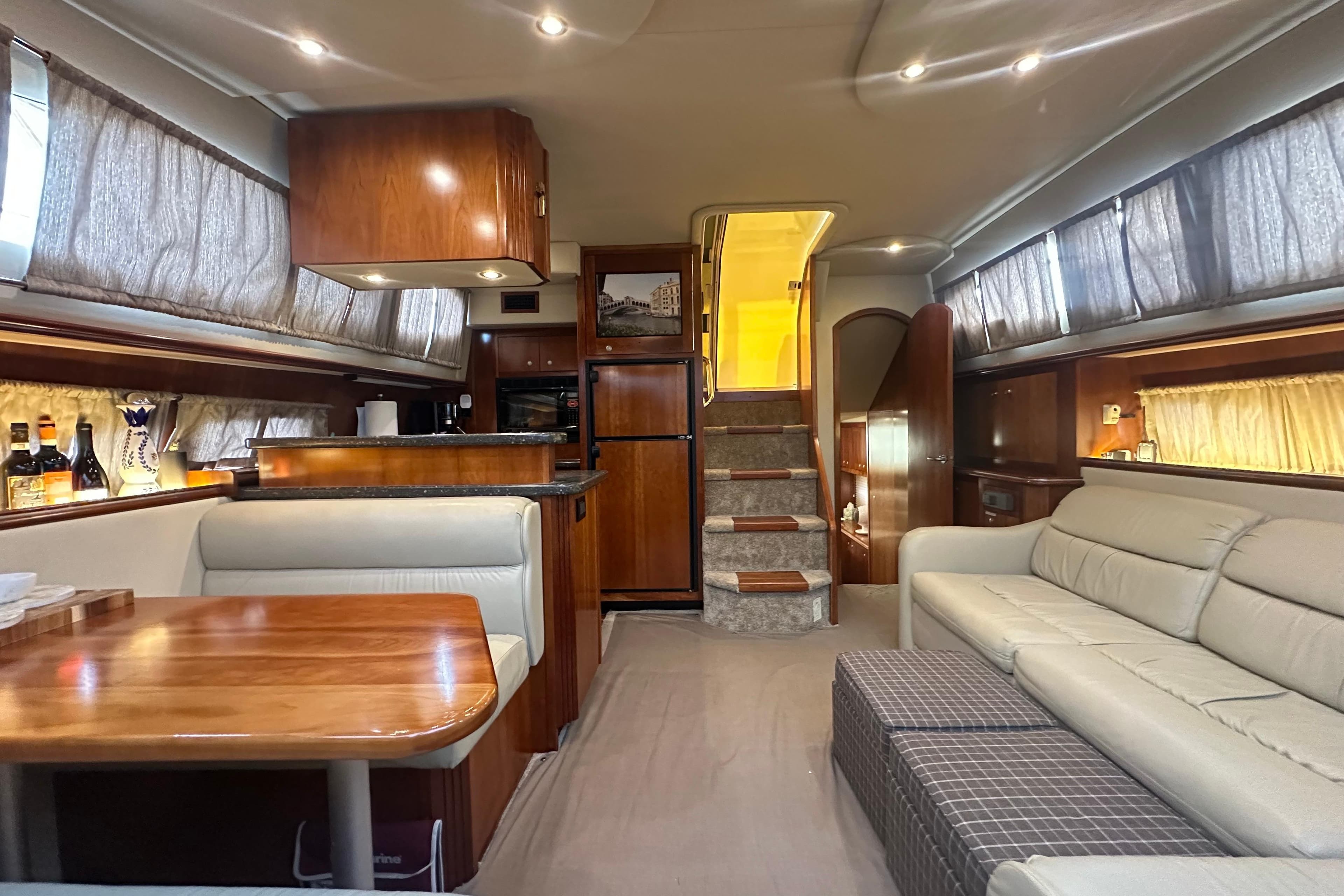 Luxurious interior of 2008 Cruisers Yachts 415 Express Motoryacht with elegant wood finishes.