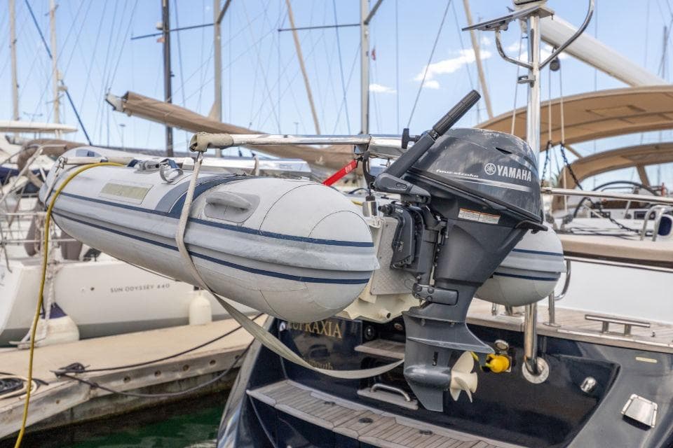 Inflatable boat with Yamaha motor on Discovery 55 yacht, 2008 model, docked at marina.