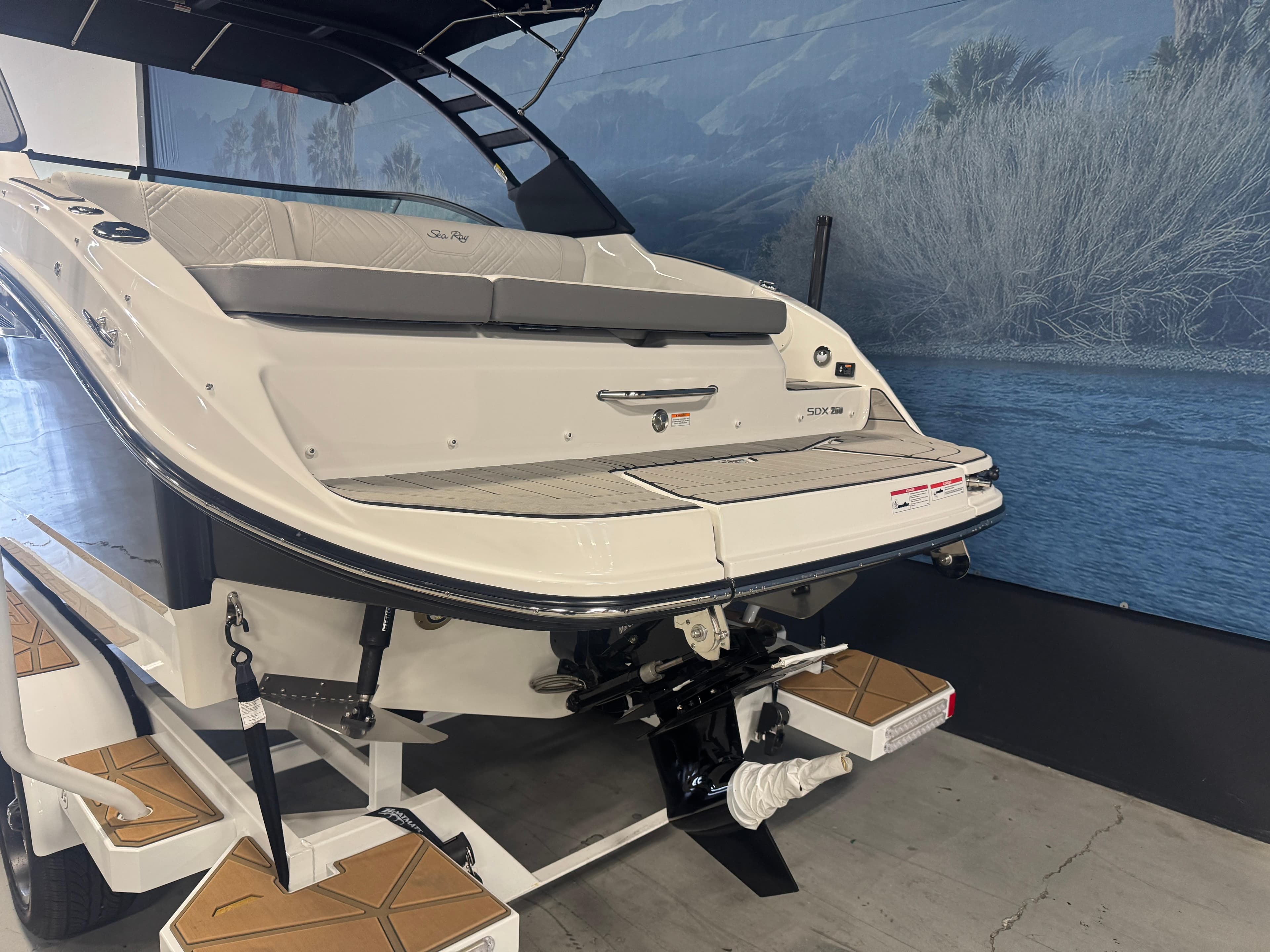2025 Sea Ray SDX 250 boat on trailer, rear view, indoor display.