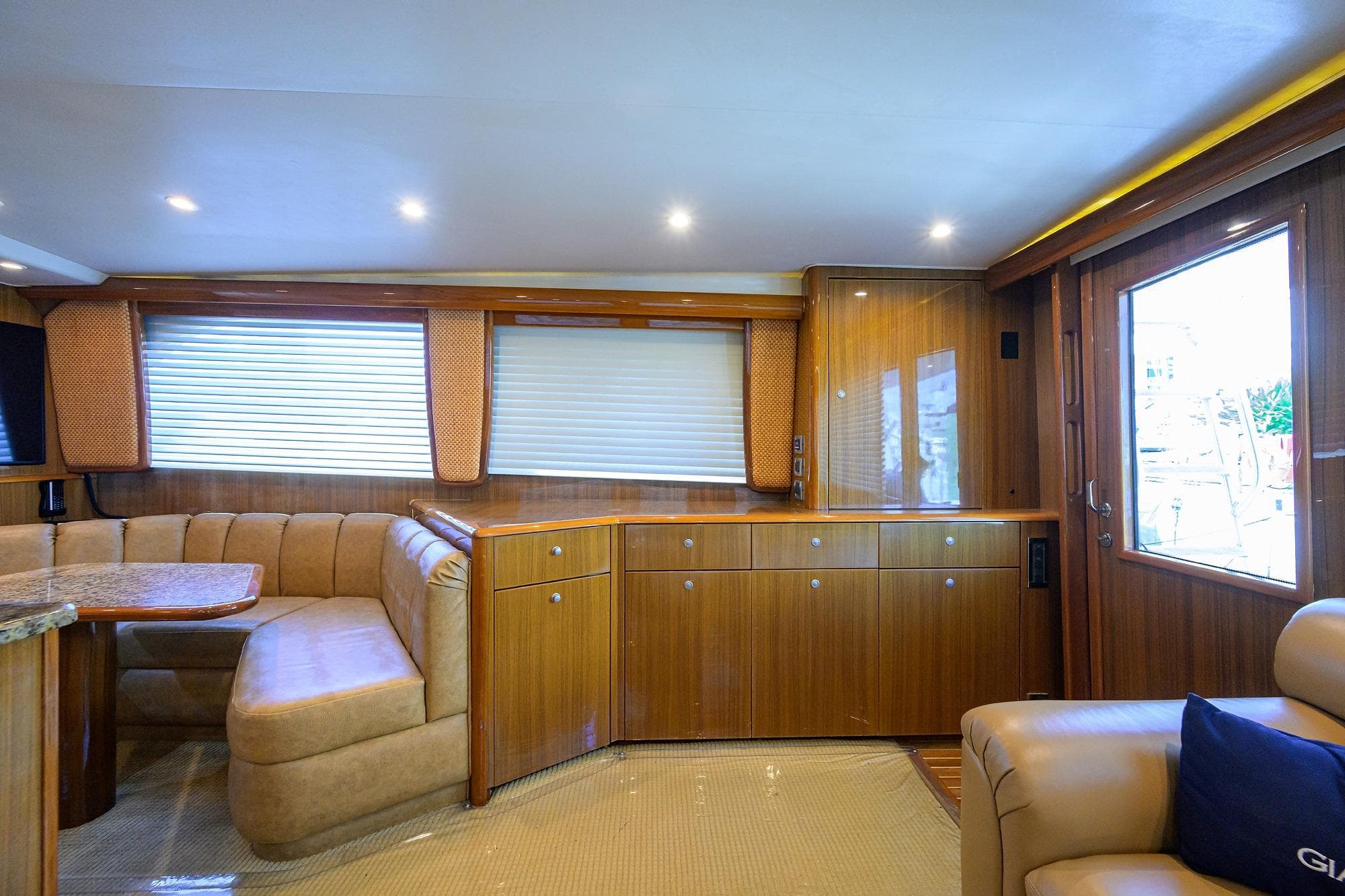 Luxurious interior of 2007 Viking 56 Convertible yacht with elegant wood finishes and plush seating.