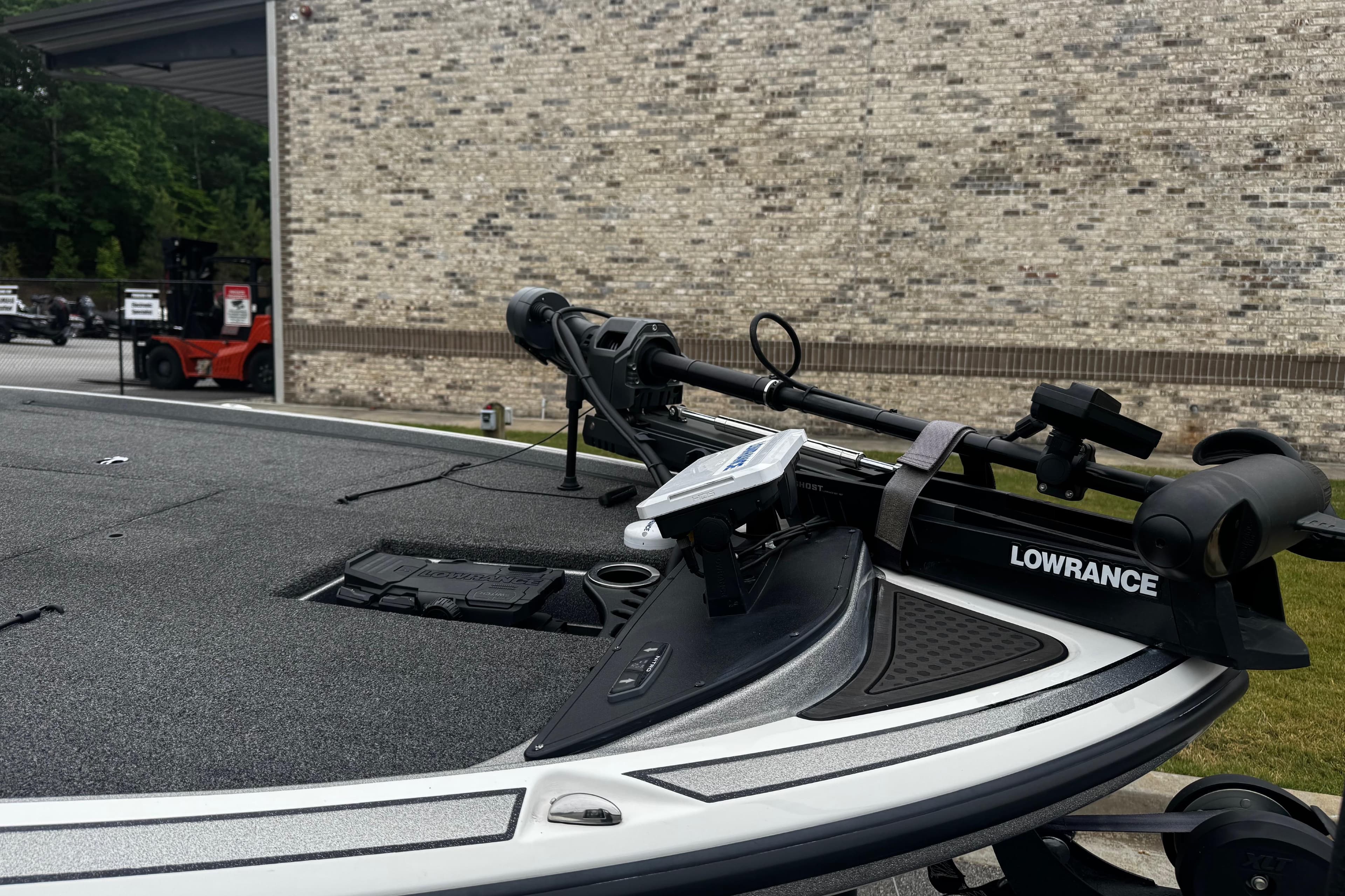 2023 Nitro Z19 boat with Lowrance equipment, parked near a brick wall.