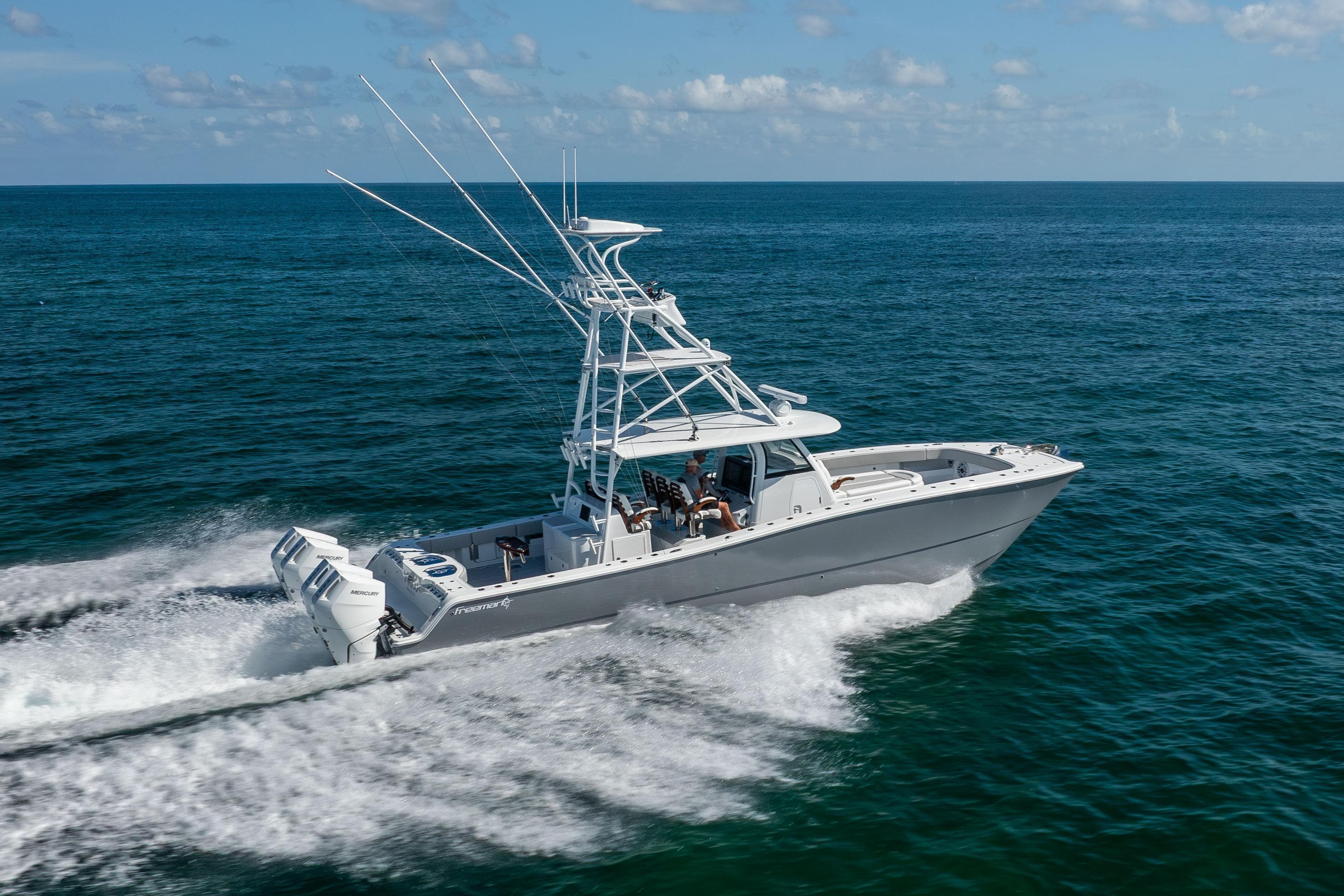 2024 Freeman 43 boat cruising on open ocean under clear skies.