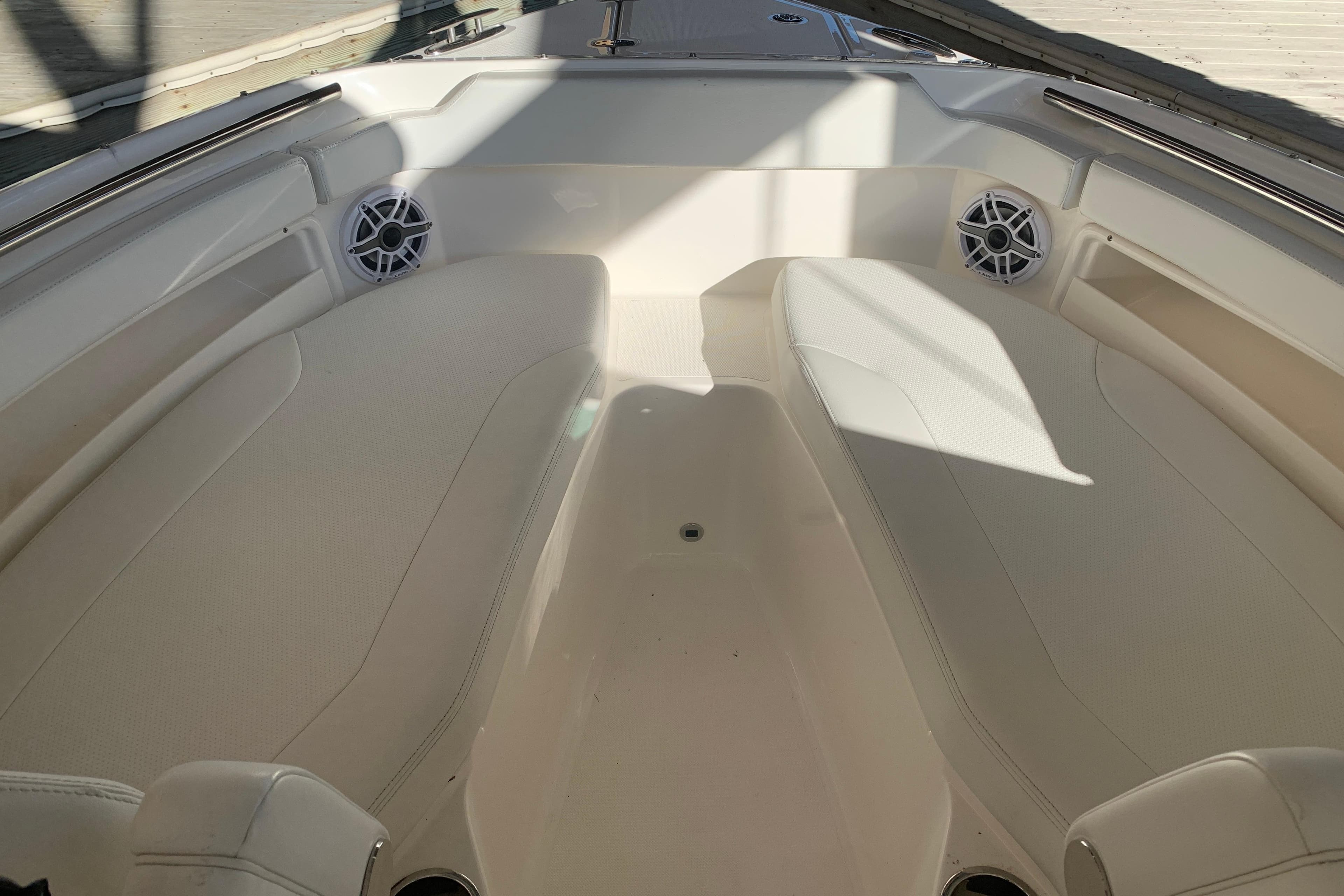 2023 Pursuit DC 266 Dual Console boat interior with cushioned seating and speakers.