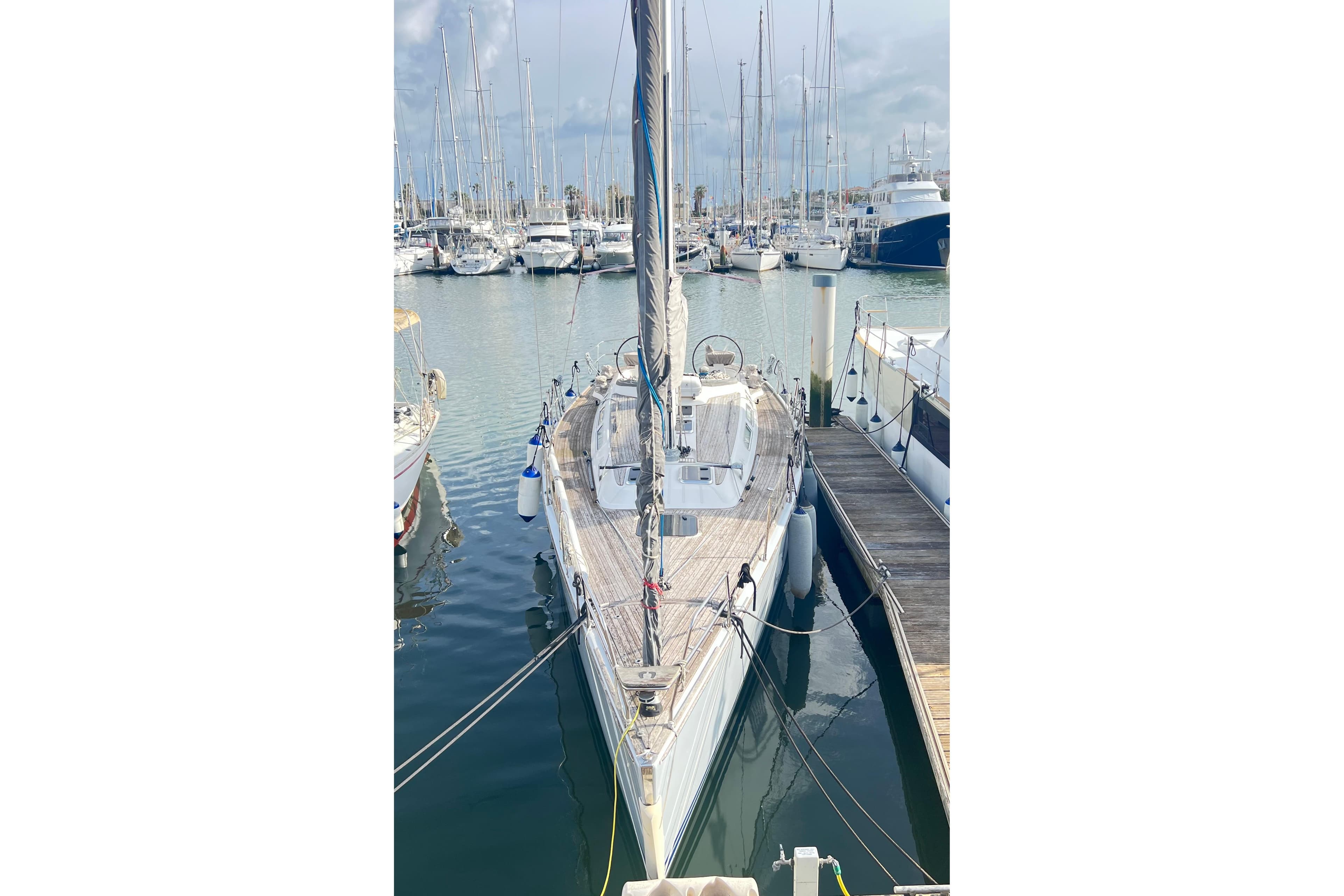 Sailboat Luffe 45, 2009 model, docked in a marina with other boats.