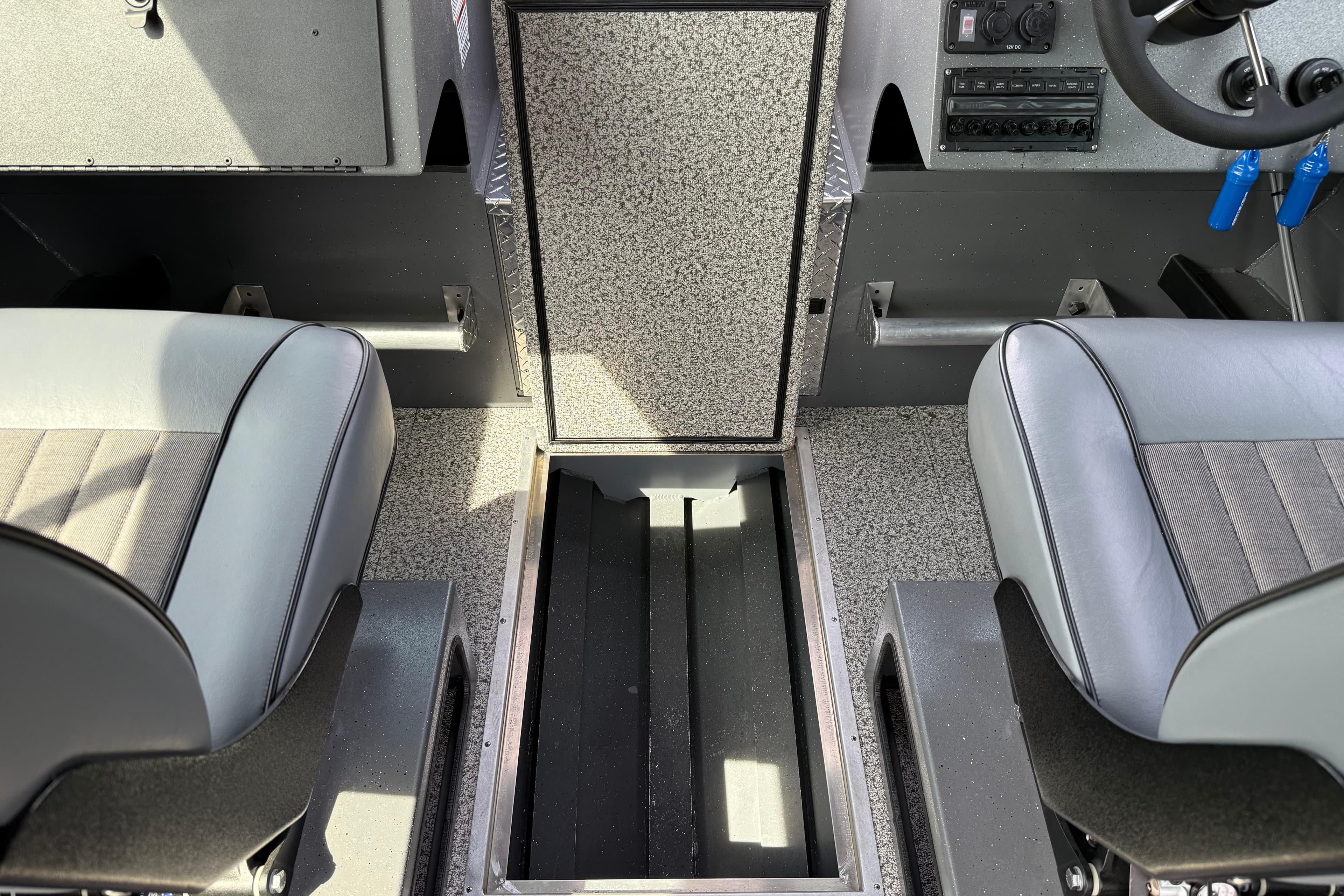 Interior of 2026 Alumaweld Horizon 26 boat showing seating and storage compartment.