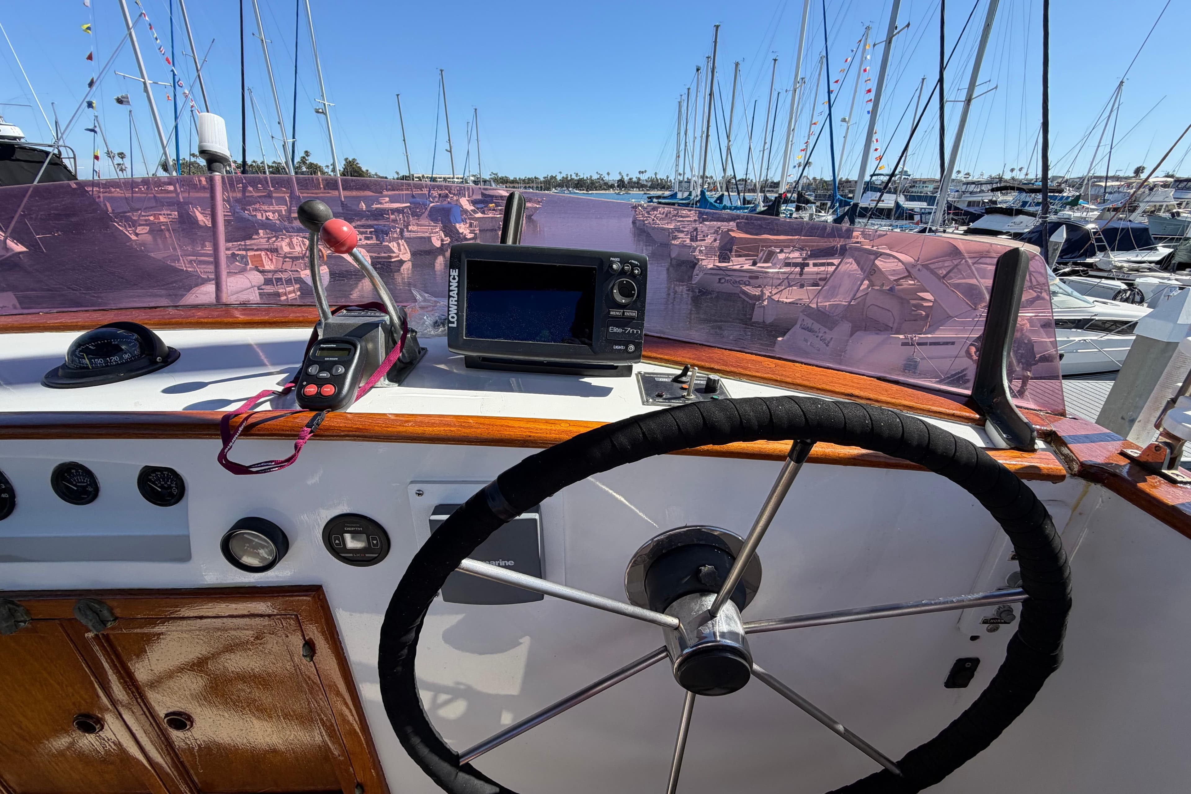 Helm of 1982 Lien Hwa 31 boat with steering wheel and navigation equipment.