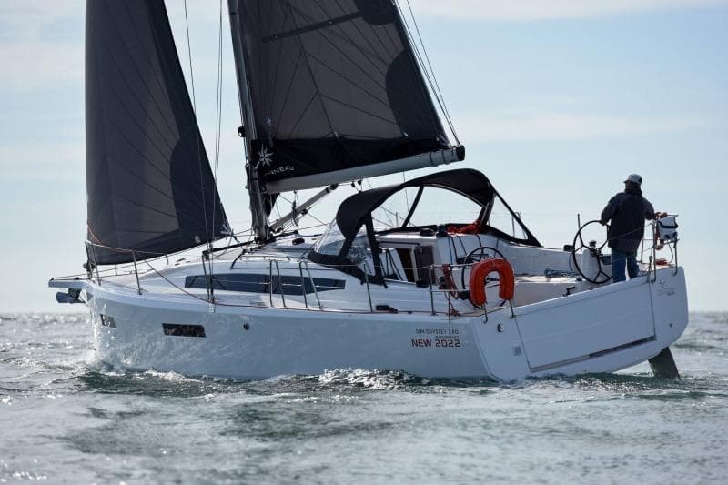 2024 Jeanneau Sun Odyssey 380 sailing on open water with black sails.