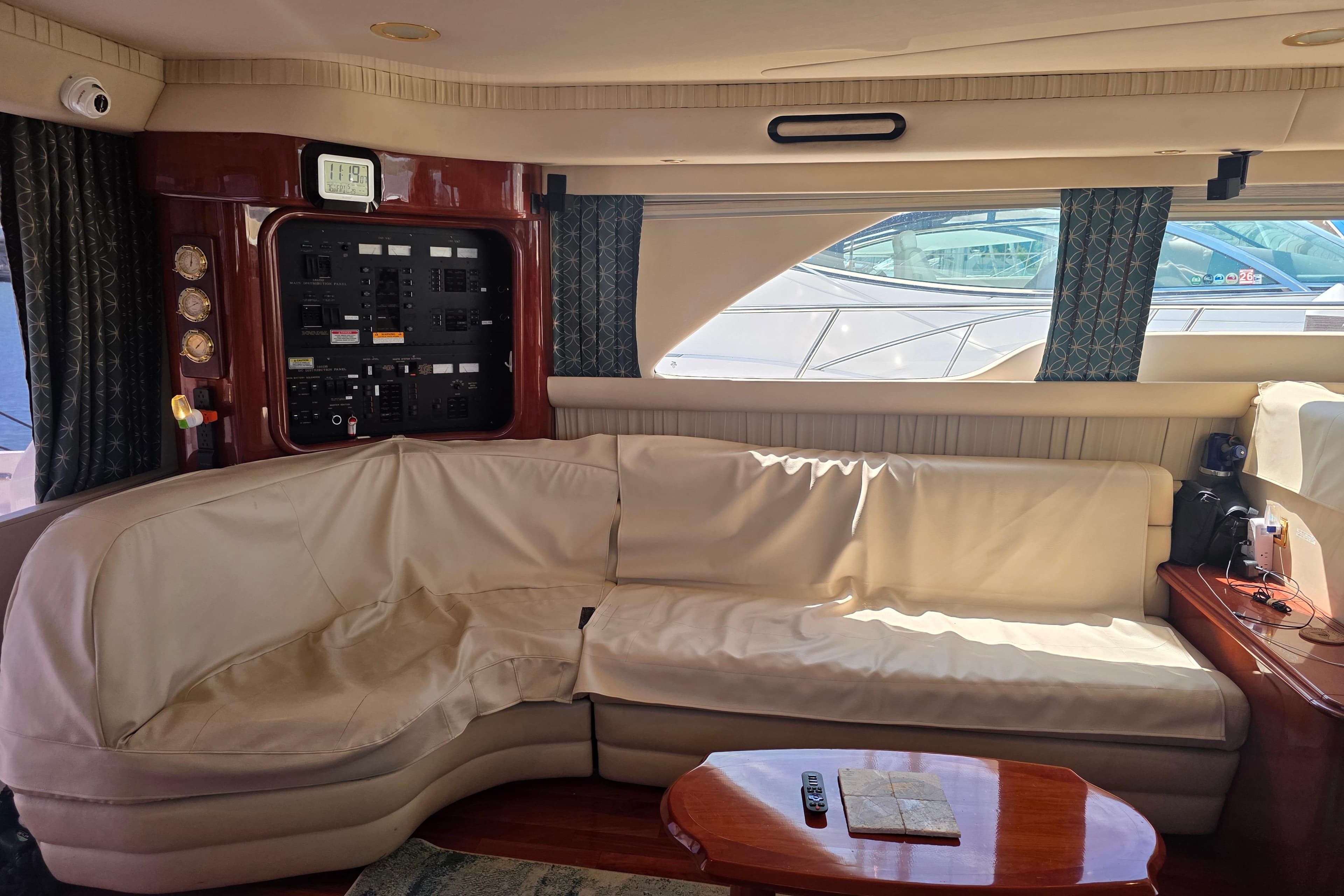 Luxurious interior of 2002 Sea Ray 560 Sedan Bridge yacht with plush seating and control panel.
