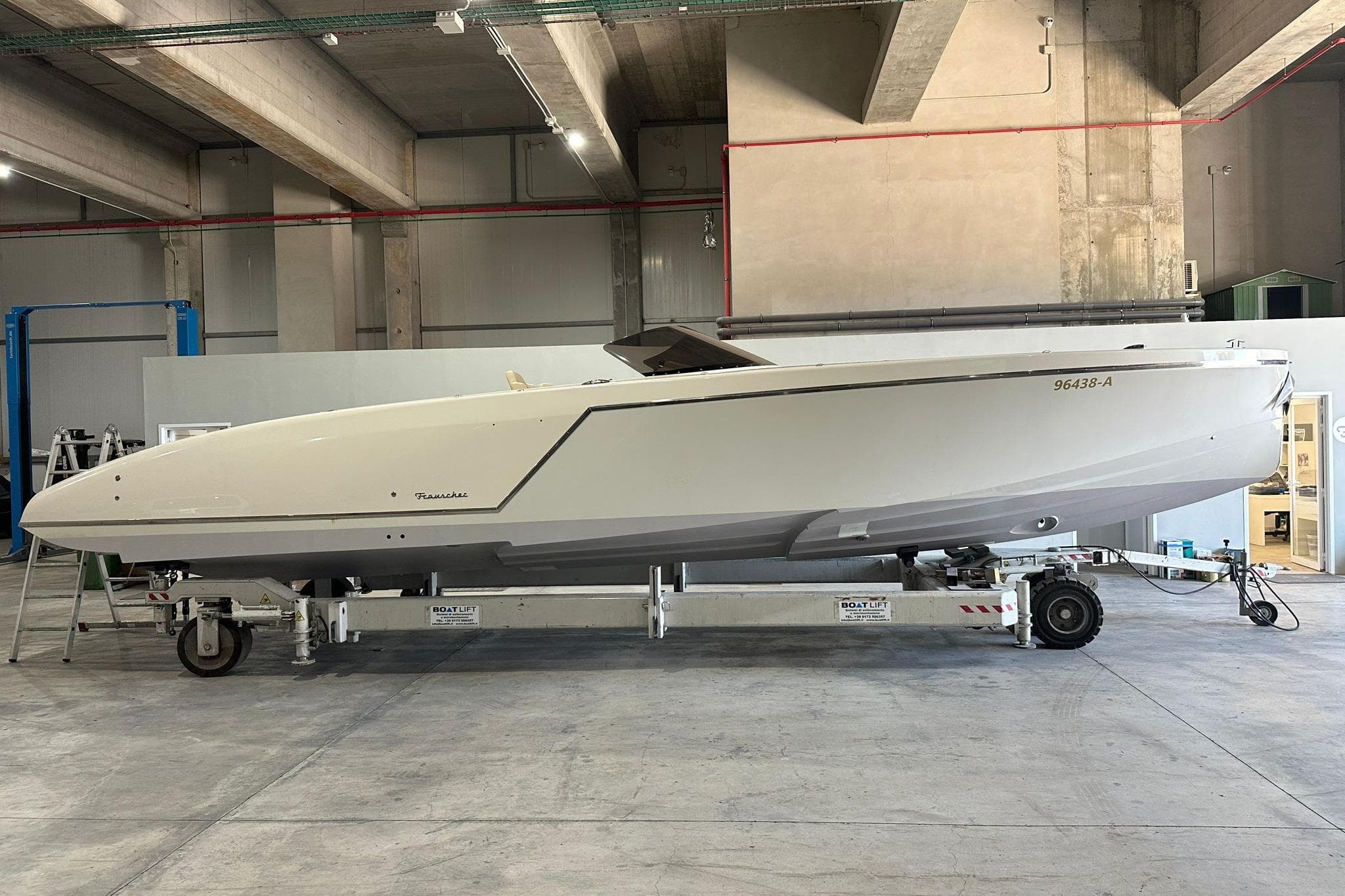 2019 Frauscher 1017 GT boat on trailer in industrial setting.