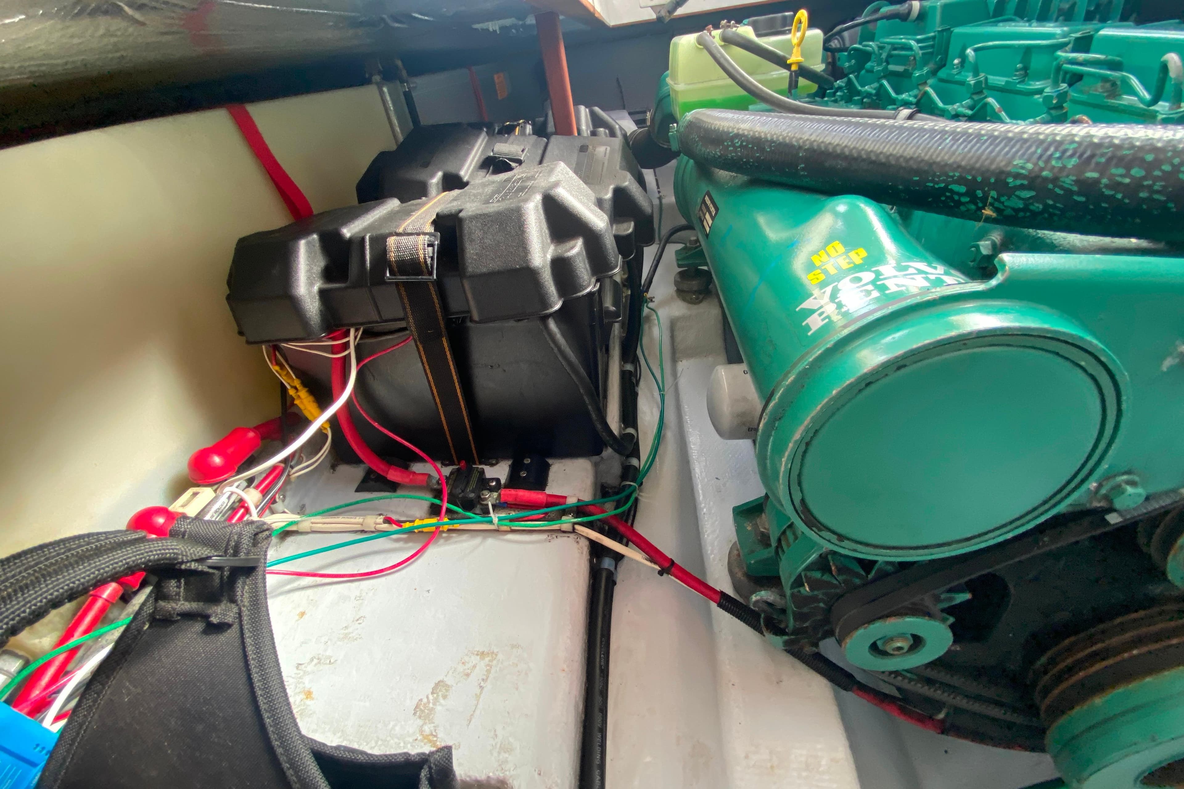 Engine compartment of Camano 30 boat with wiring and battery box.