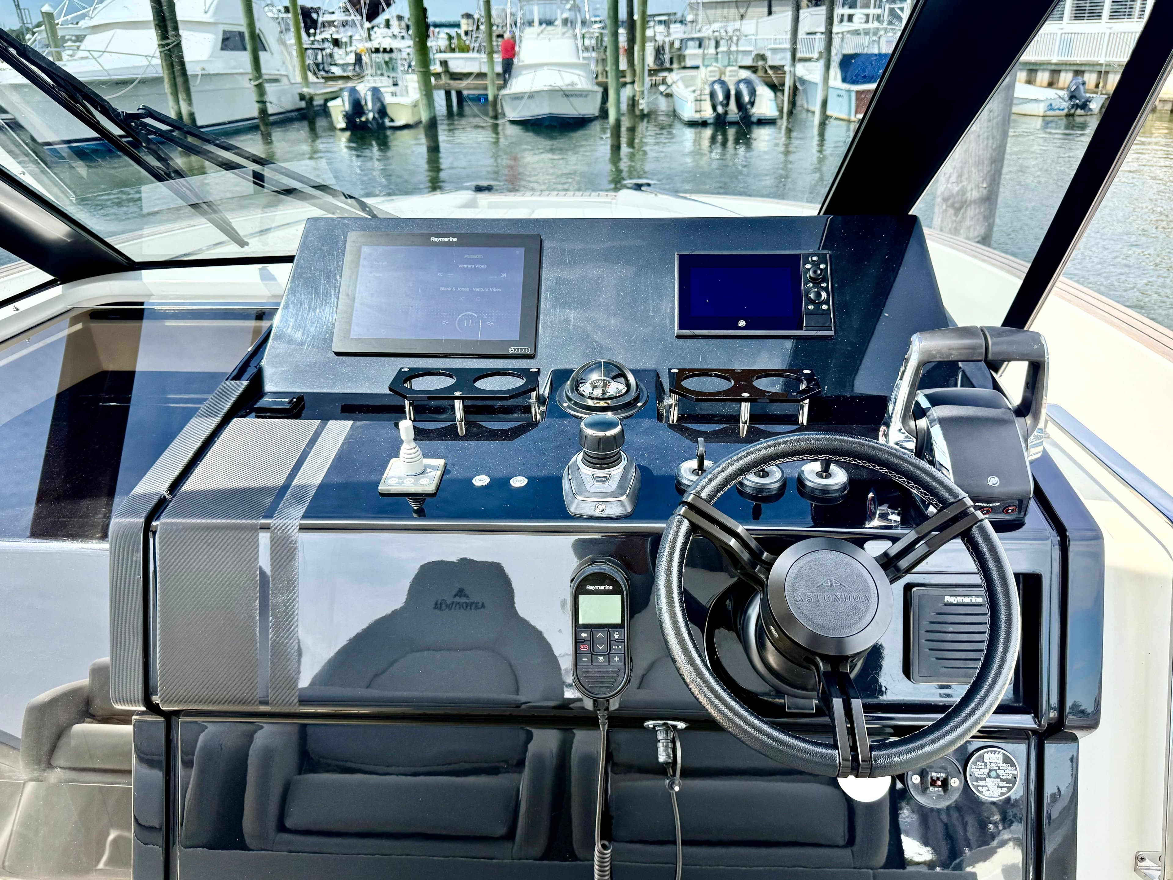 2023 Astondoa 377 Coupe Outboard helm with modern controls and navigation screens.
