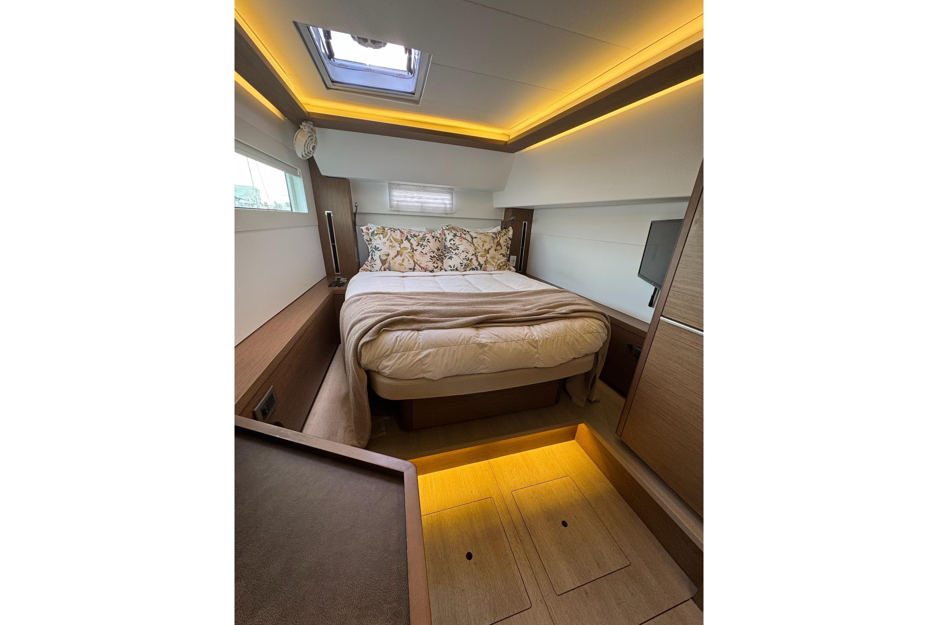 Luxurious cabin interior of 2020 Lagoon 46 yacht with cozy bed and ambient lighting.