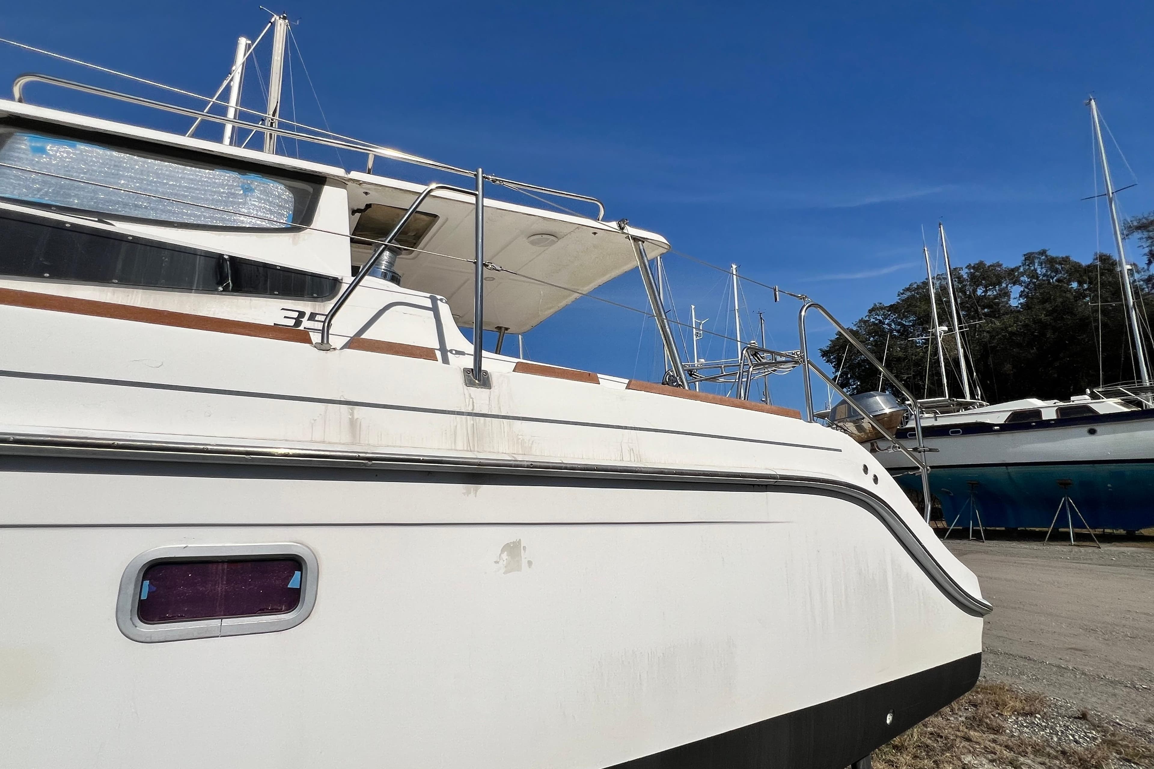2013 Gemini Legacy 35 catamaran on land, clear sky background.