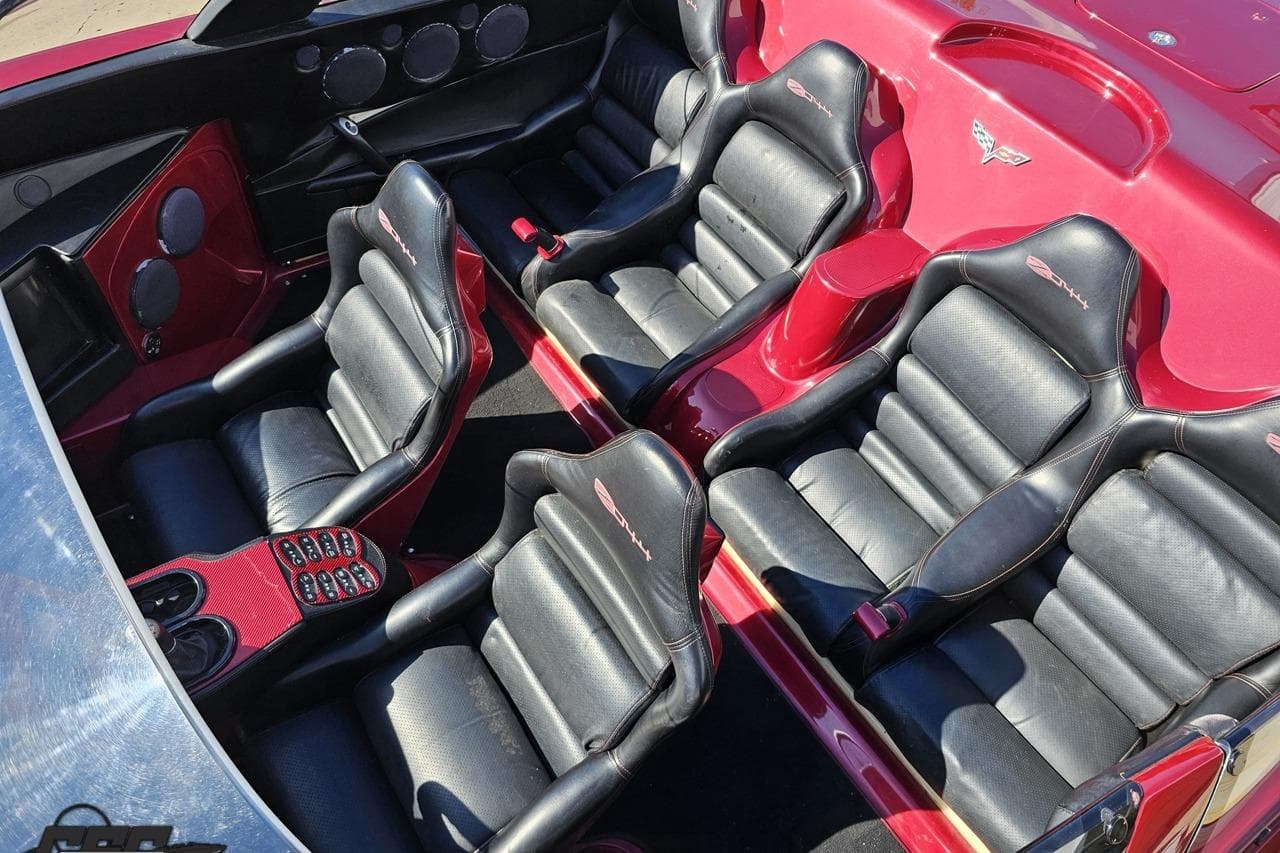 Interior of a 2010 MTI 44 Corvette with black leather seats and red accents.