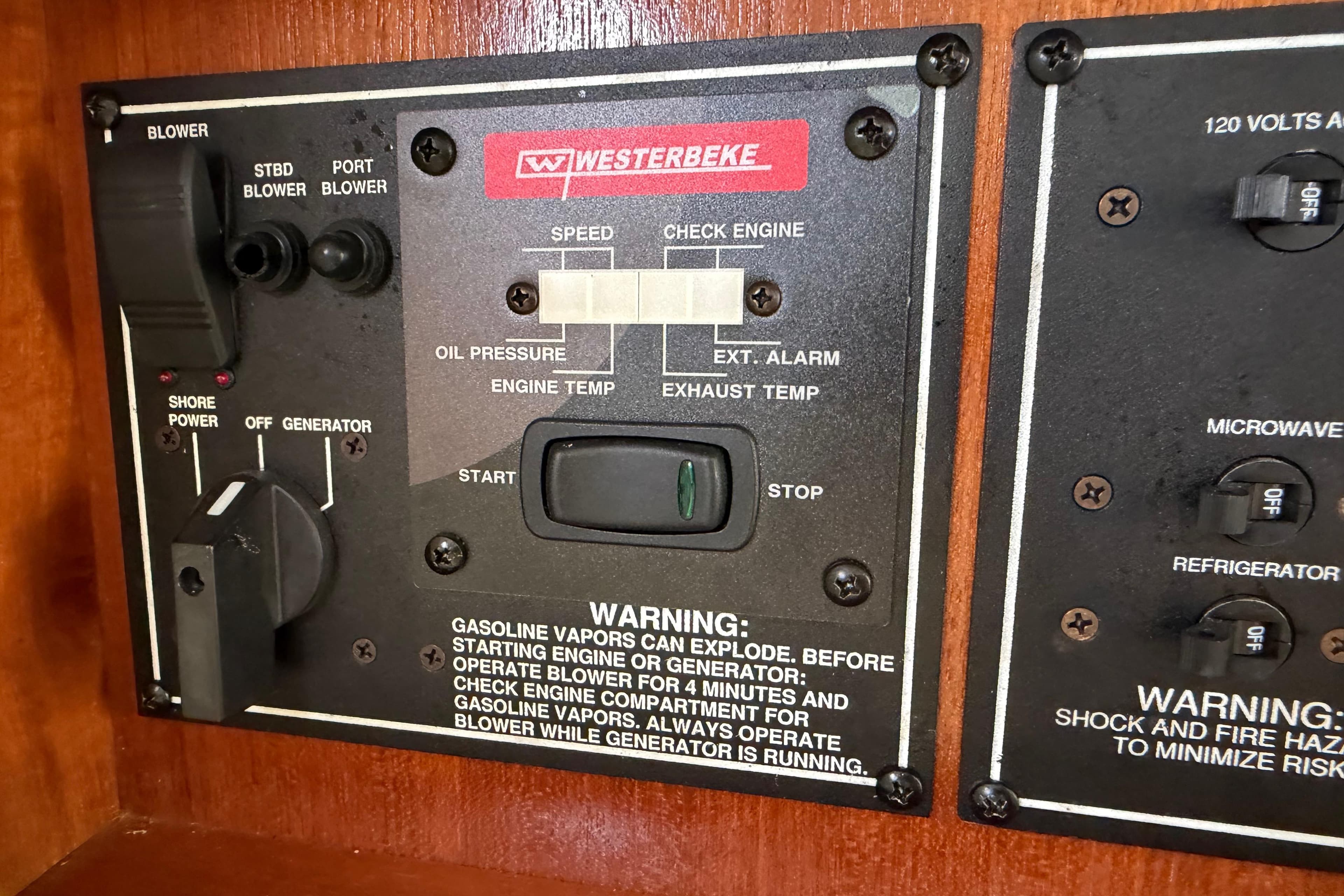 Control panel of a 2008 Pursuit OS 335 Offshore boat with Westerbeke generator controls.