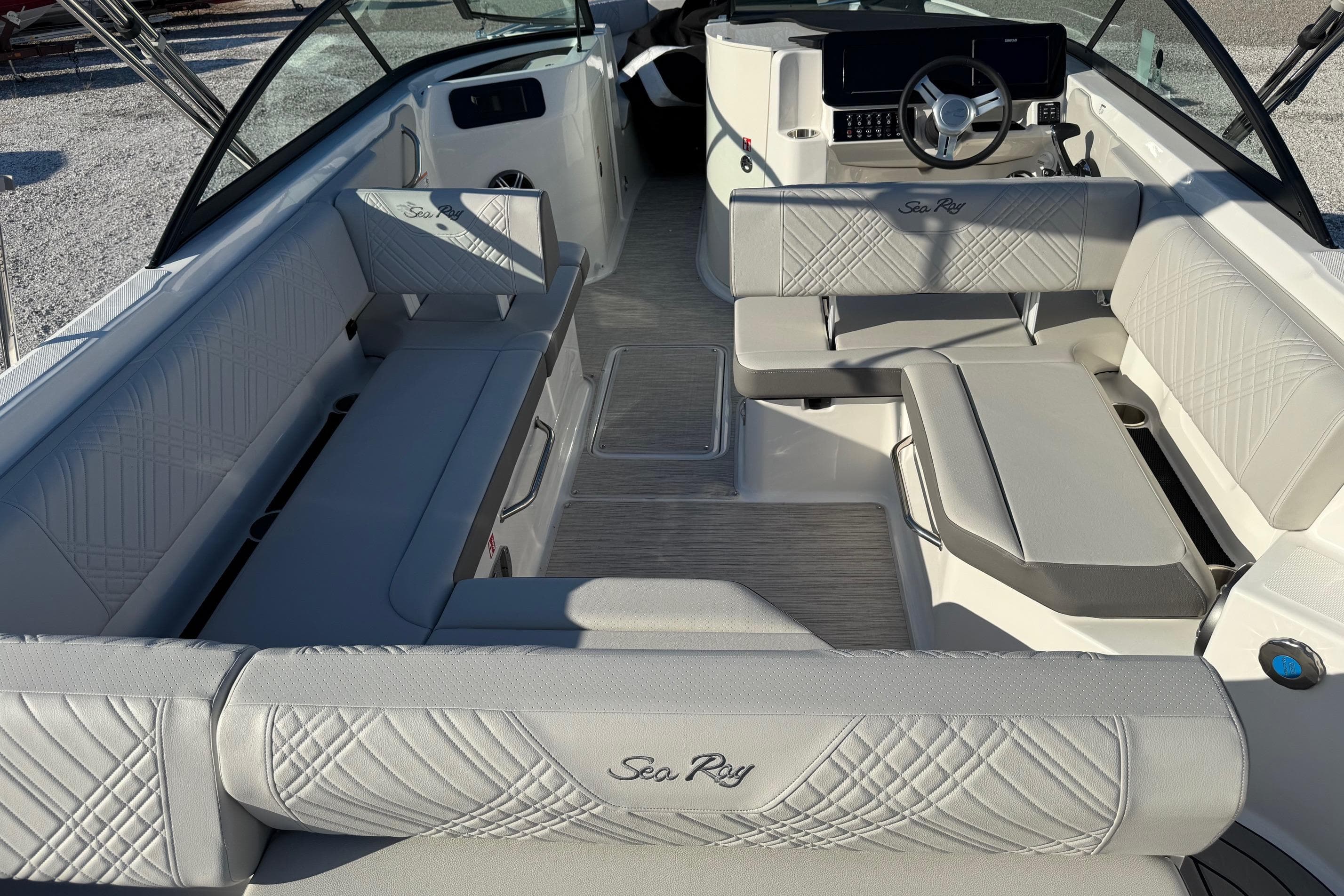 2026 Sea Ray SDX 230 boat interior with luxurious seating and modern dashboard.