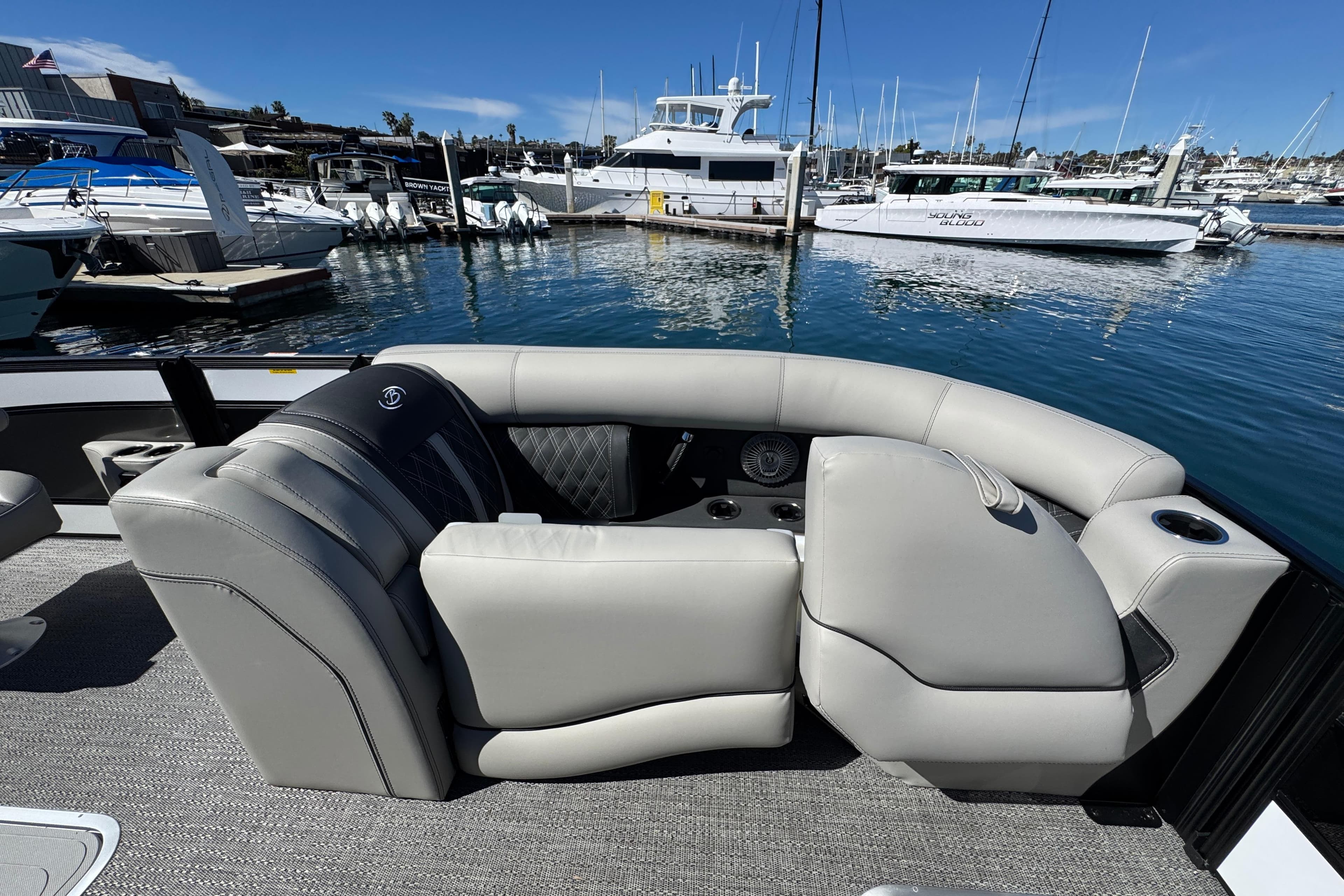 2026 Barletta Lusso 23UC pontoon boat interior with luxurious seating at marina.