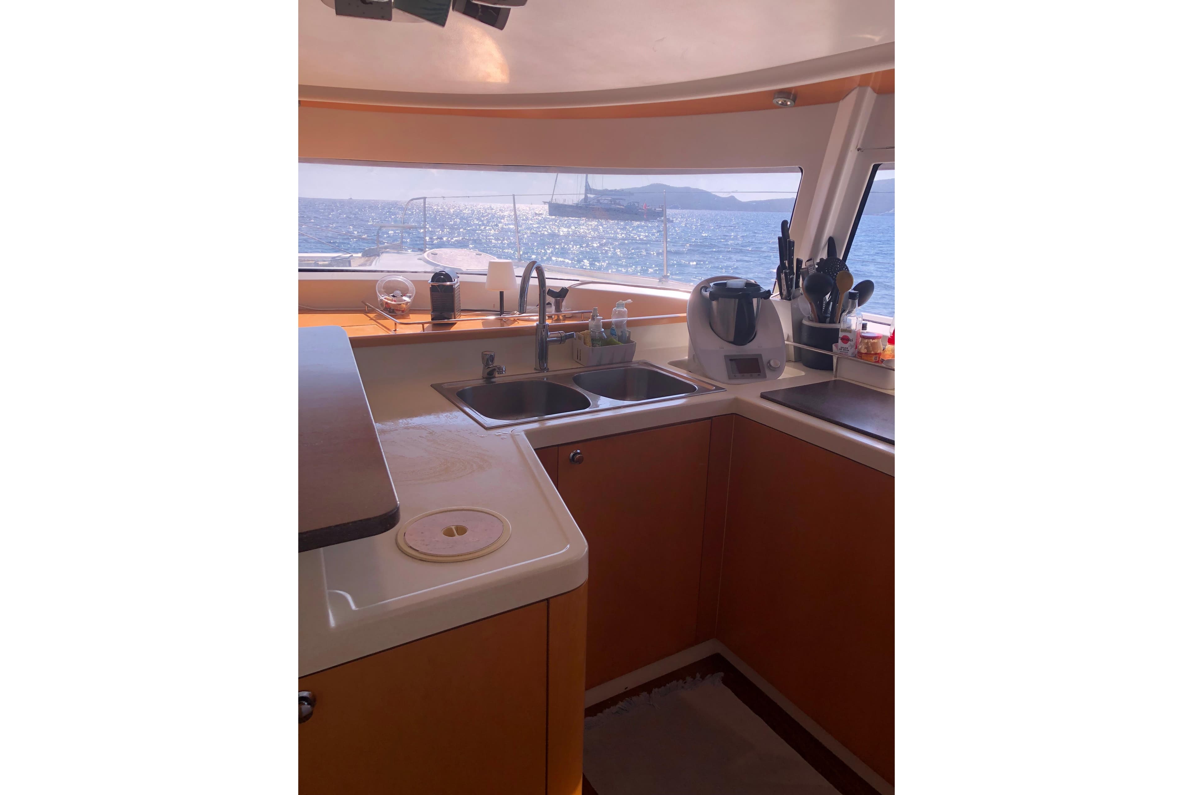 Interior view of 2009 Fountaine Pajot Salina 48 yacht kitchen with ocean view.