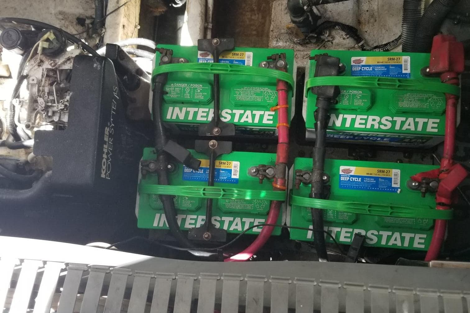 Engine compartment of a 2004 Sea Ray 300 Sundancer with Interstate deep cycle batteries.