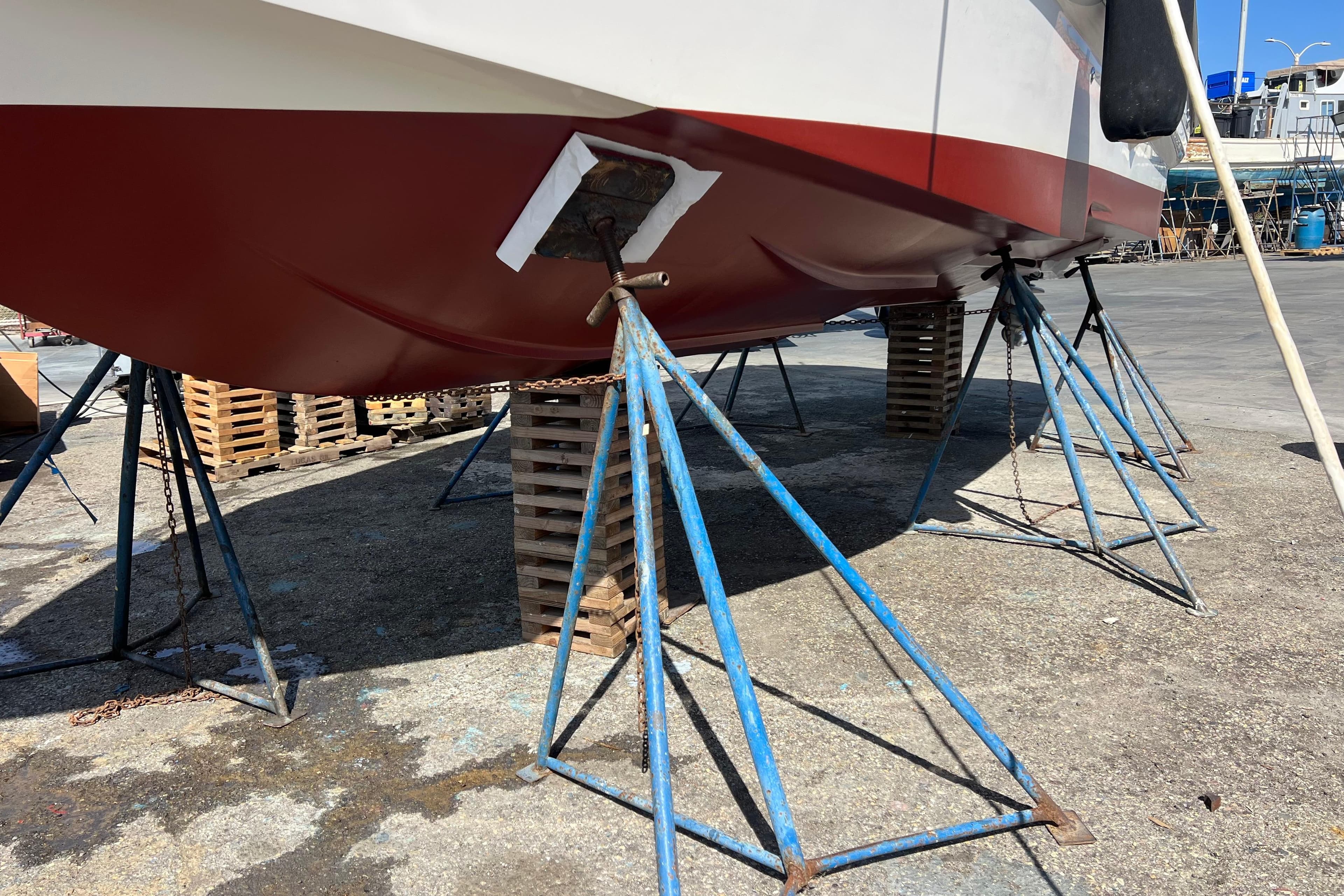2007 Larson Cabrio 310 boat on stands for maintenance at a shipyard.